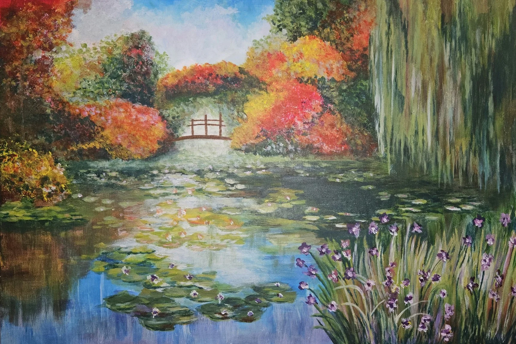 An Impressionist-style painting of a tranquil pond with lily pads and purple flowers, surrounded by trees with vibrant autumn foliage, and a small wooden bridge in the background.