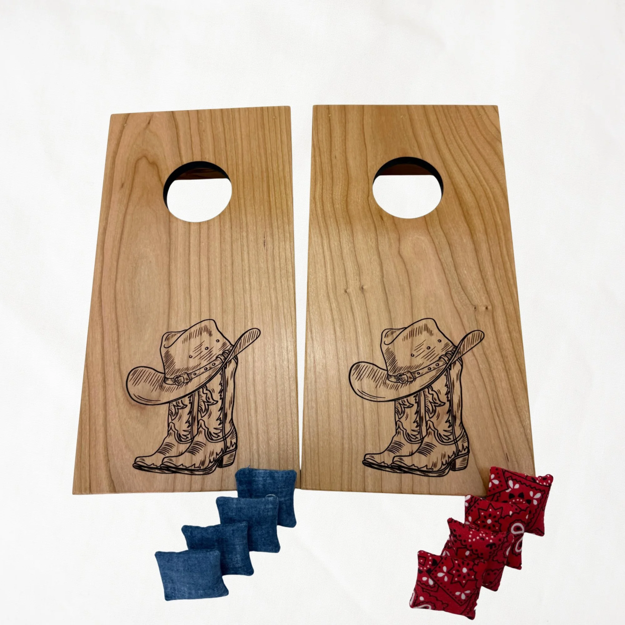 Handcrafted tabletop mini cornhole boards made from solid hardwood, cherry wood, engraved with cowboy boots