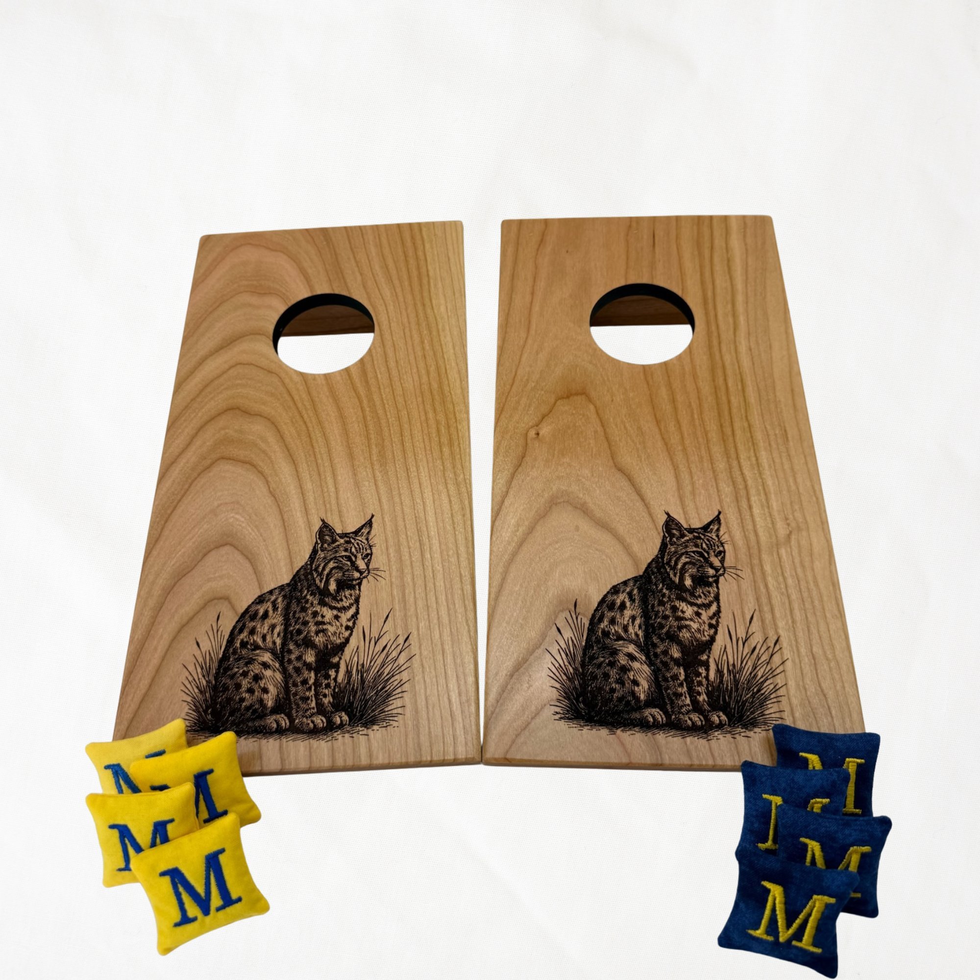 Handcrafted tabletop mini cornhole boards made from solid hardwood, cherry wood, engraved with bobcat