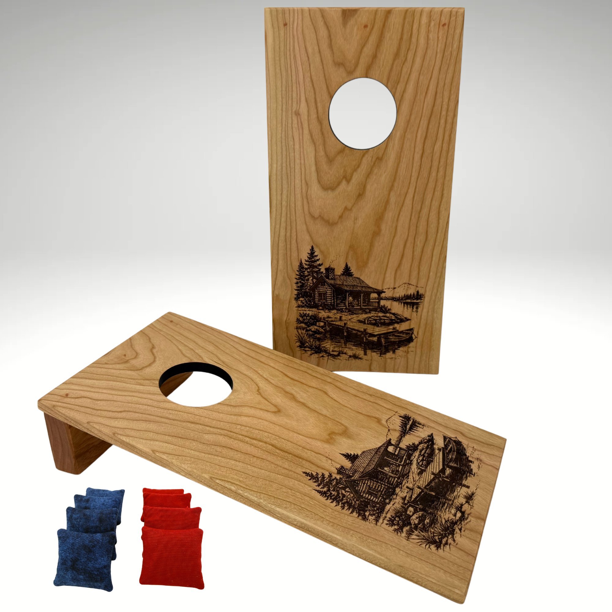 Handcrafted tabletop mini cornhole boards made from solid hardwood, cherry wood, and engraved with a cabin