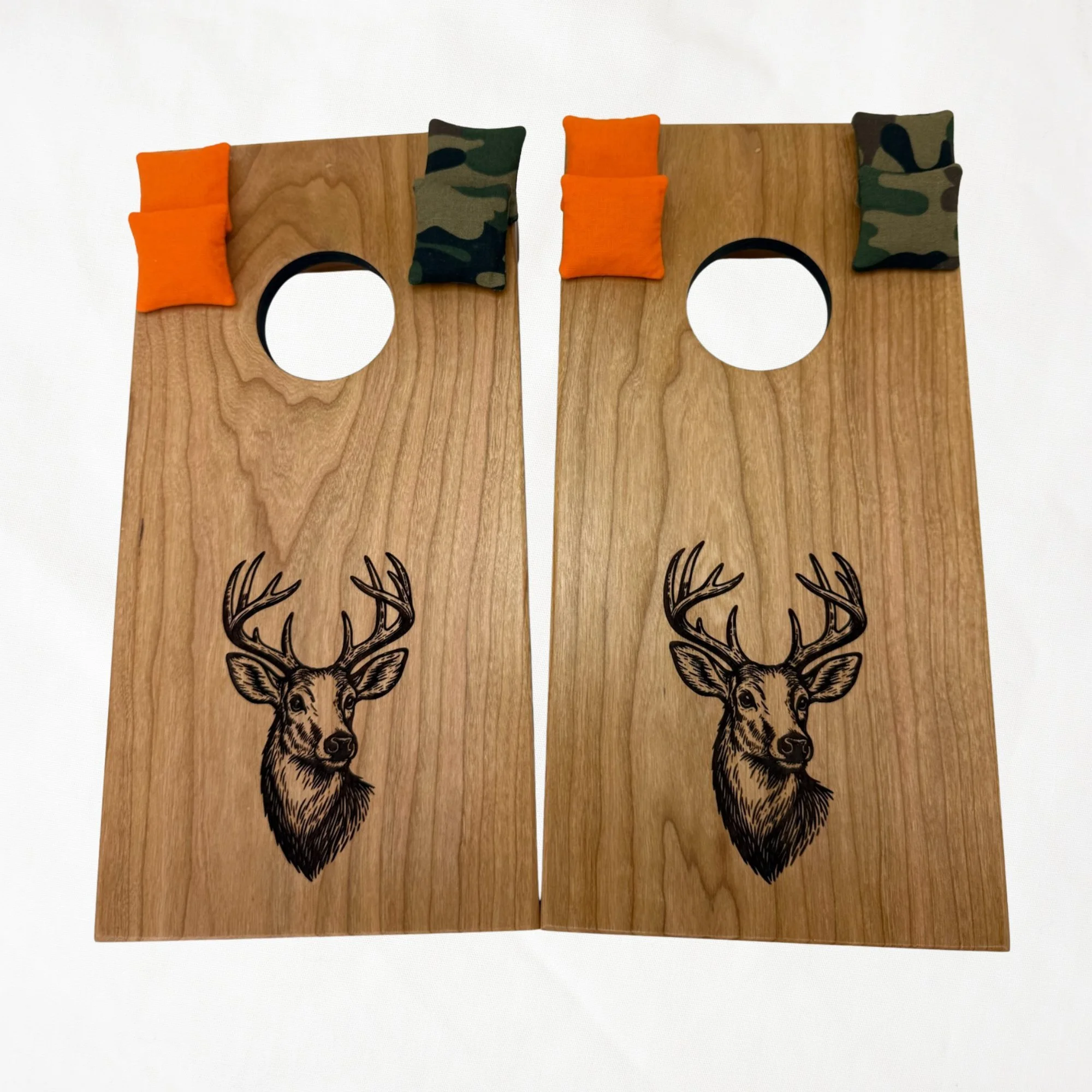 Handcrafted tabletop mini cornhole boards made from solid hardwood, cherry wood, engraved with deer