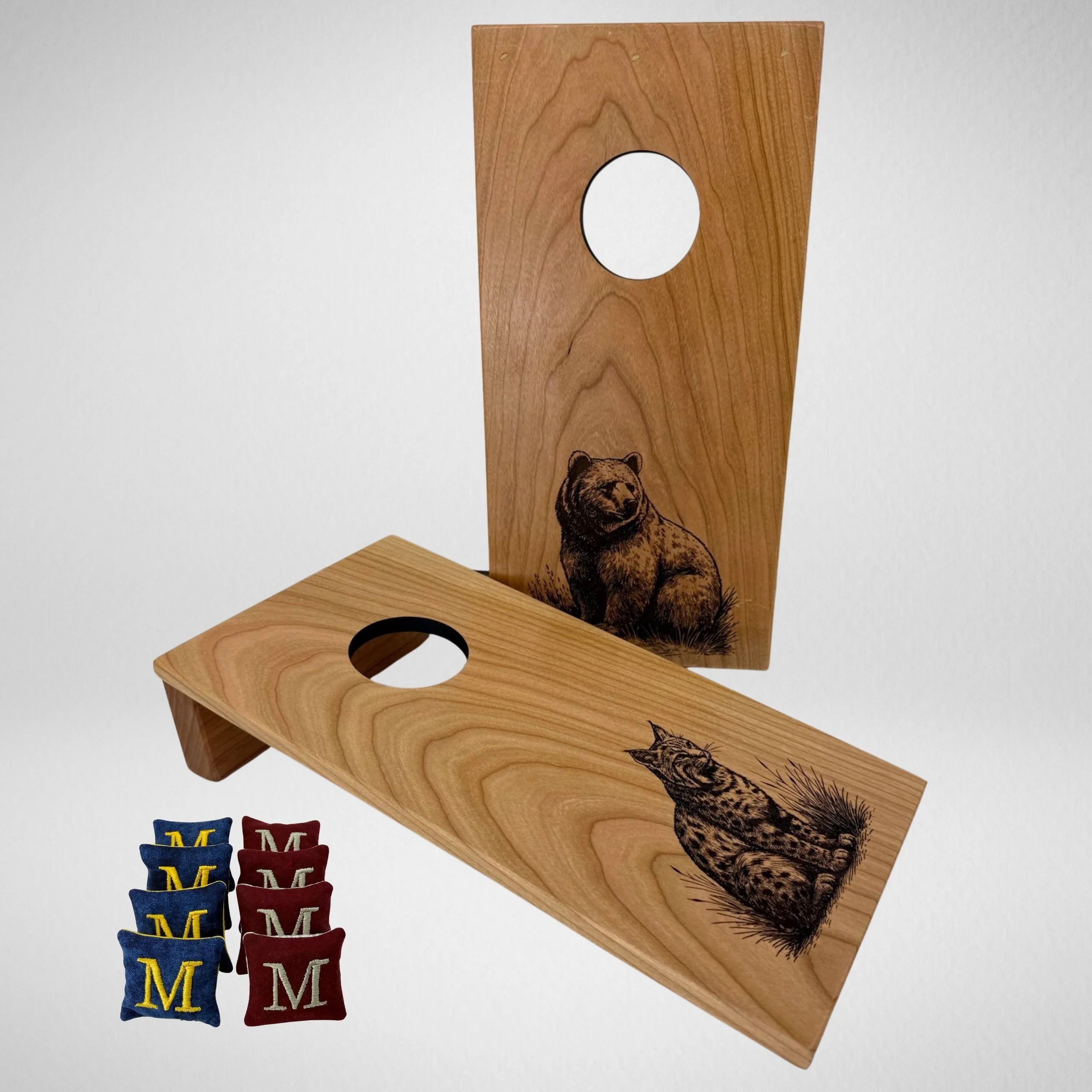 Handcrafted tabletop mini cornhole boards made from solid hardwood, cherry wood, engraved with grizzly & bobcat