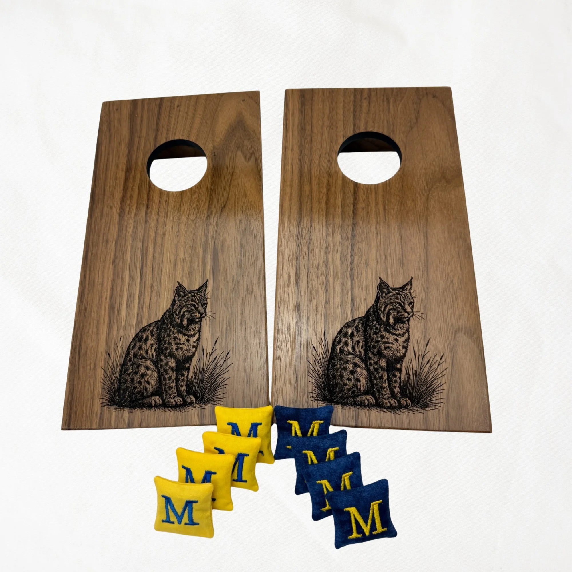 Handcrafted tabletop mini cornhole boards made from solid hardwood, walnut wood, engraved with bobcat