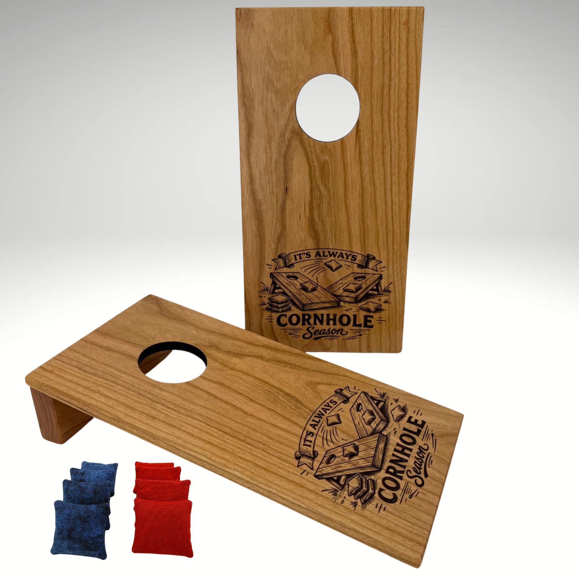 Handcrafted tabletop mini cornhole boards made from solid hardwood, cherry wood, and engraved with cornhole season