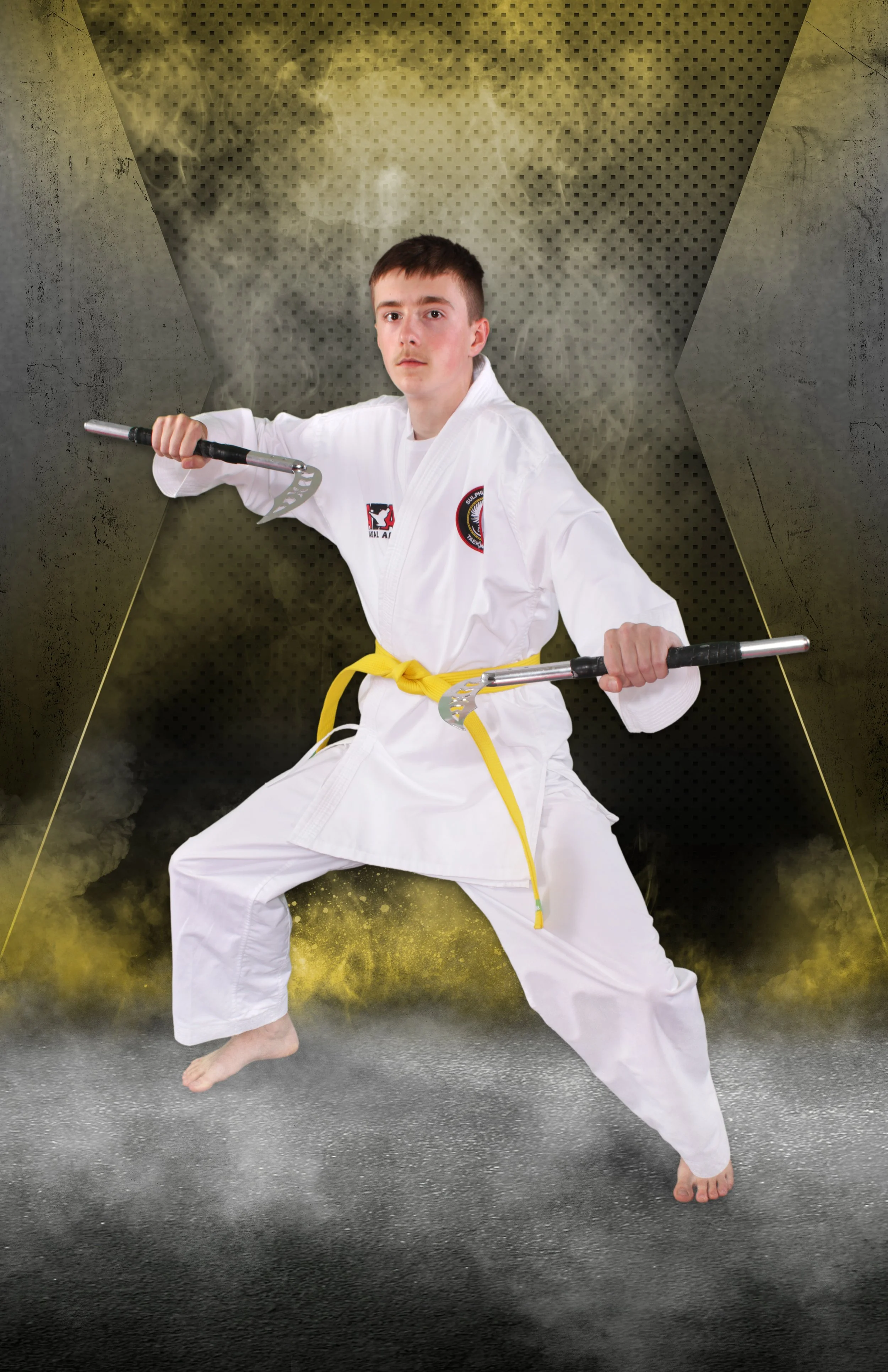 an image of a teenage boy holding martial arts weapons