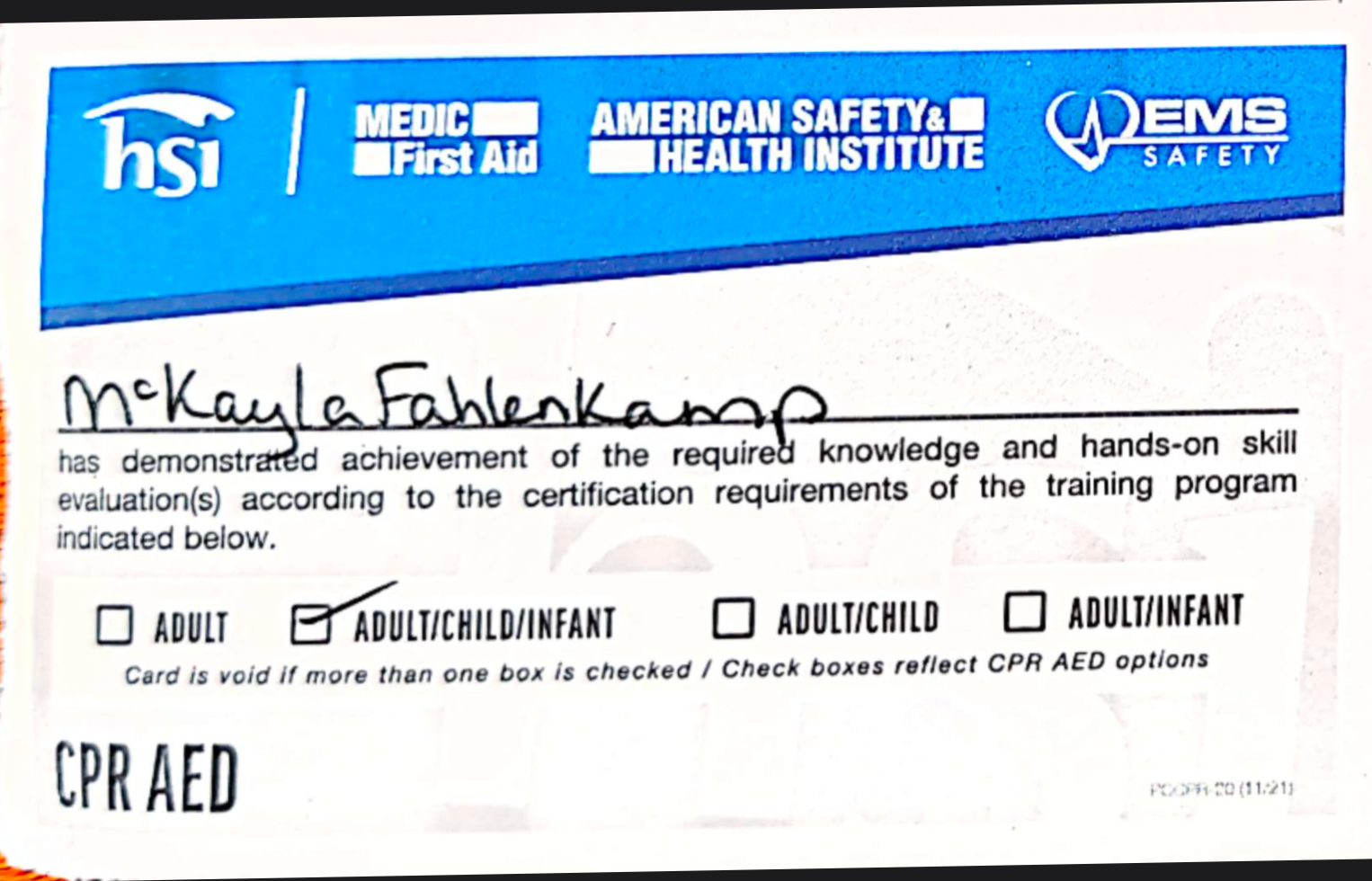 A CPR/AED certification card issued to McKayla Fahlenkamp, with logos from HSI, American Safety & Health Institute, and EMS Safety, showing her certification level and name handwritten on the card.