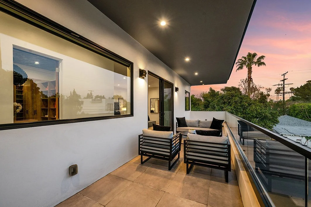 Long rectangular window and sliding door on the on the balcony of a west Los Angeles modern home at sunset.