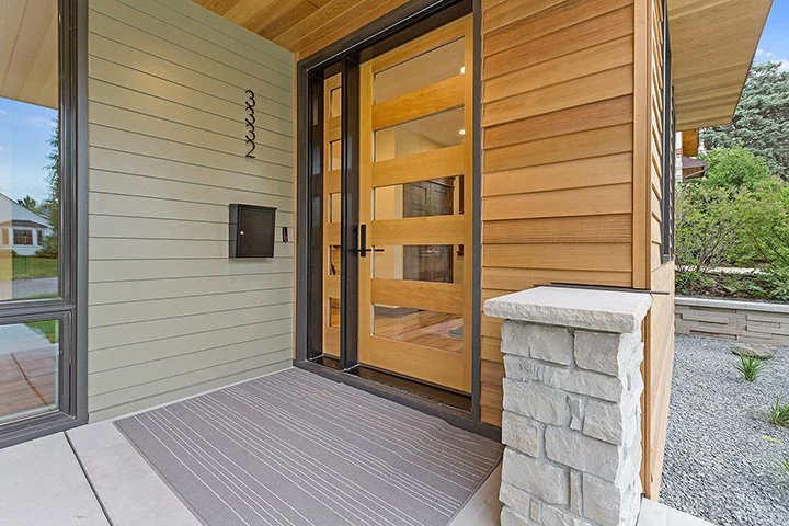 Large, modern wood and glass entry door.