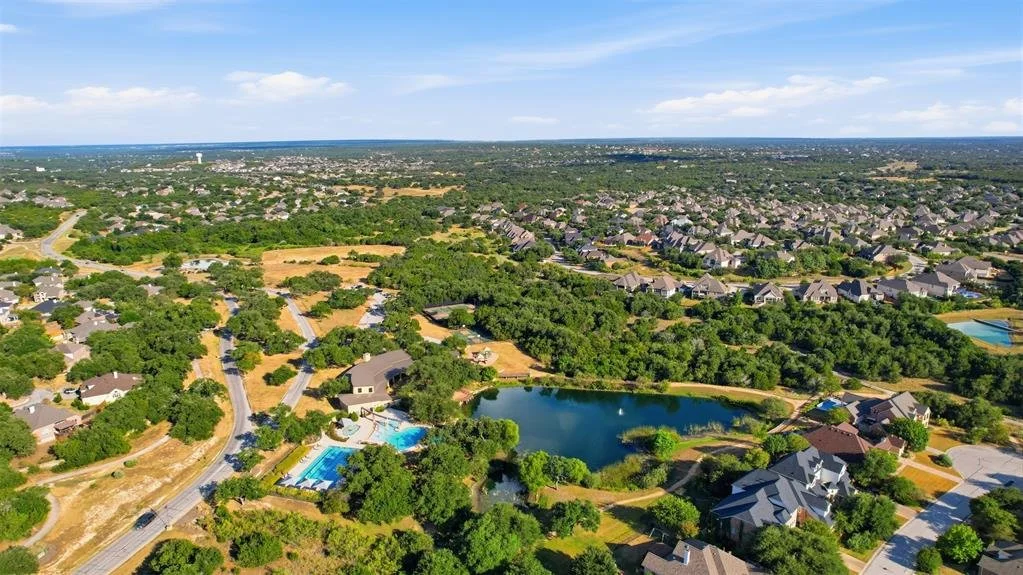 Aerial view of homes and Hill Country greenbelt in Dripping Springs, Texas