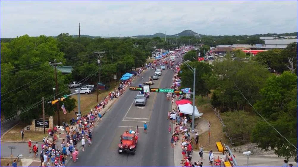 Aerial view of crowds lining the Fourth of July parade route in Wimberley, Texas