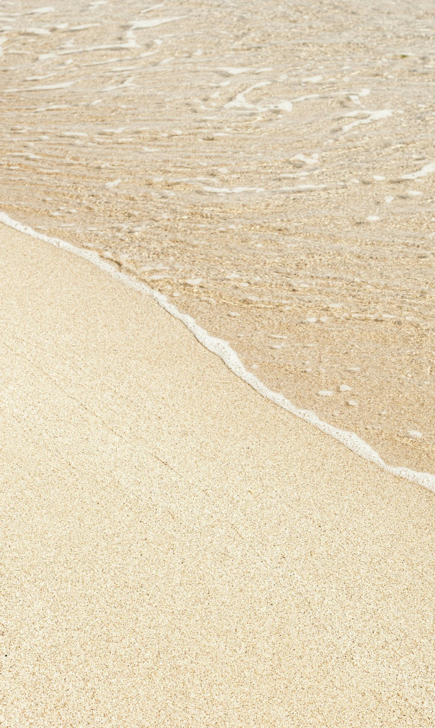 beige sand on beach with gentle wave