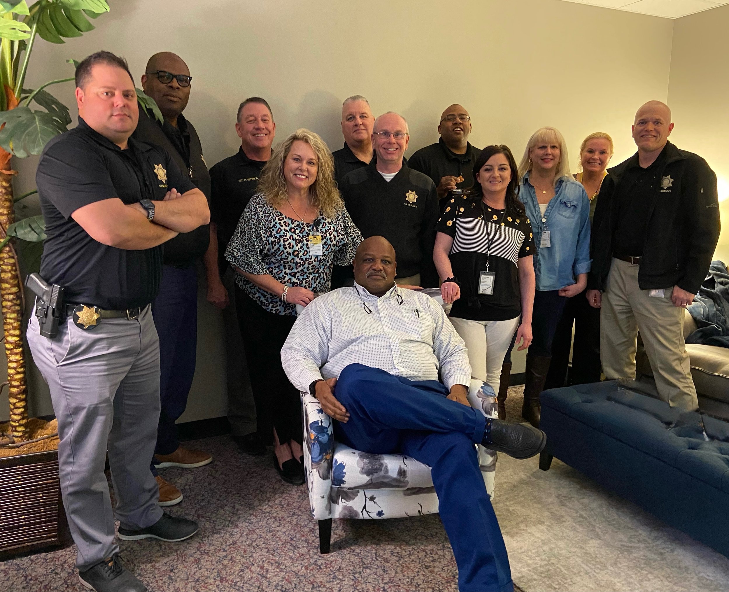 Group of Police Officers standing around a man in a chair