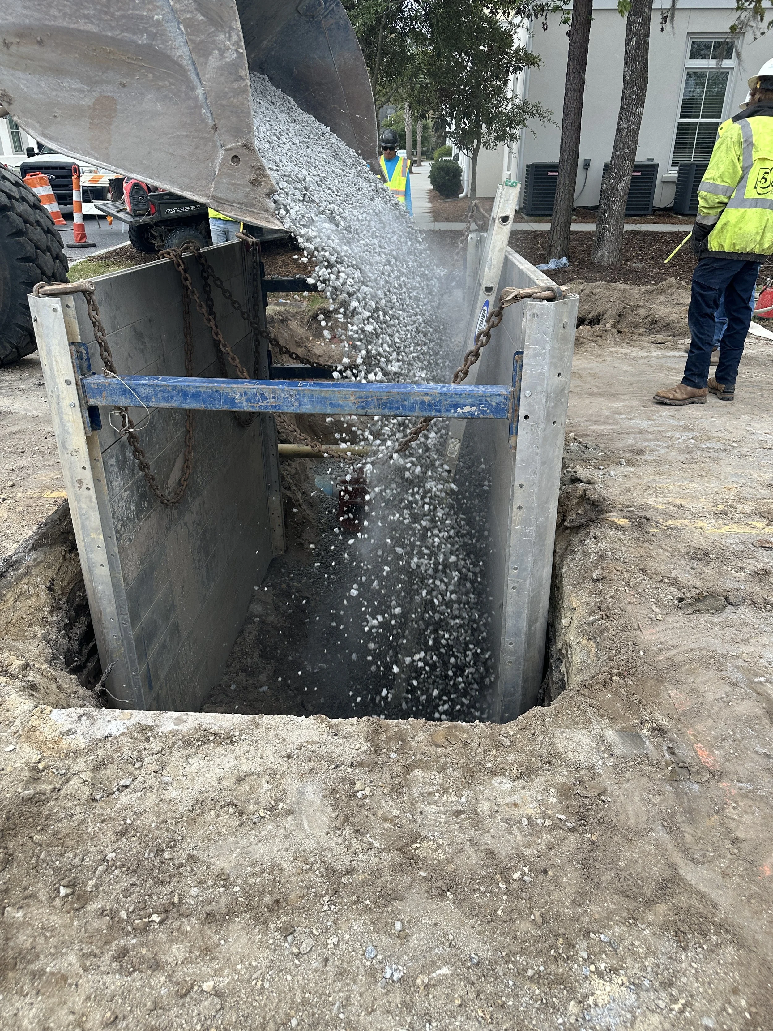 57 stone being added for bedding to new water pipes