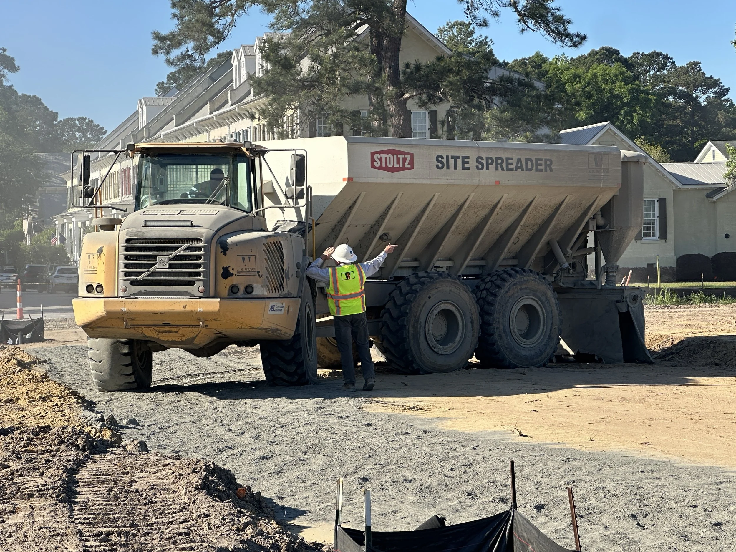 J.R. Wilson site spreader preparing another pass of spreading cement for soil cement mix on a new road in Pondcrest Phase of Habersham.