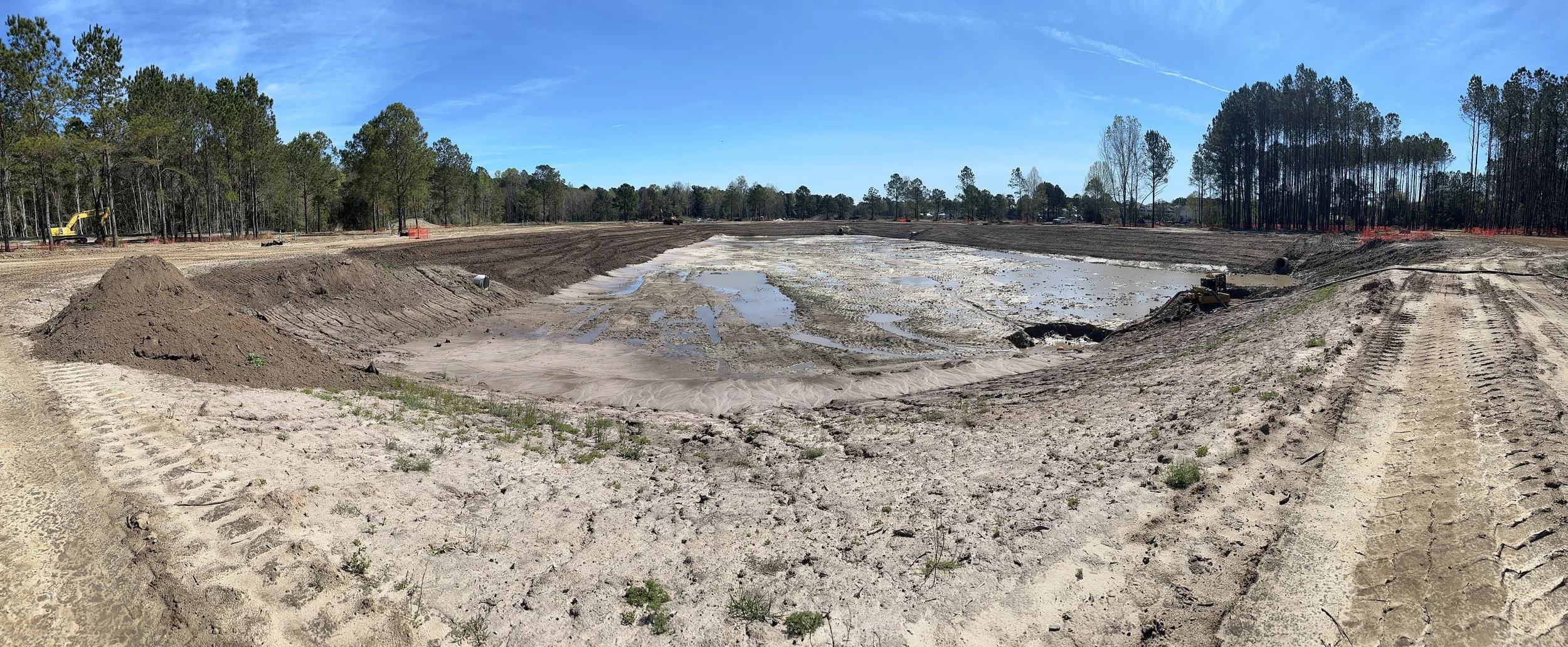 panorama of pond under construction and completely dug out