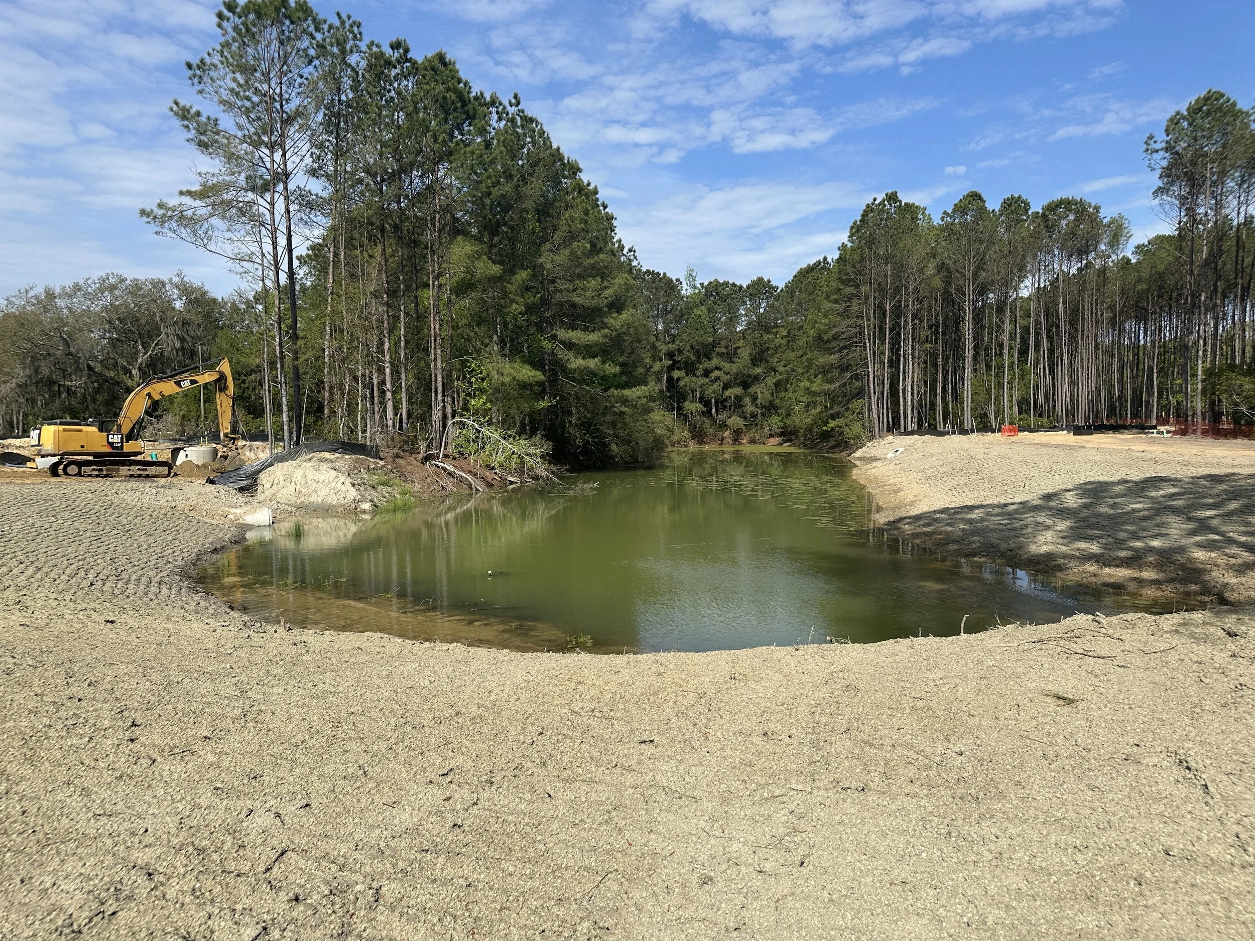 pond banks being graded for grassing