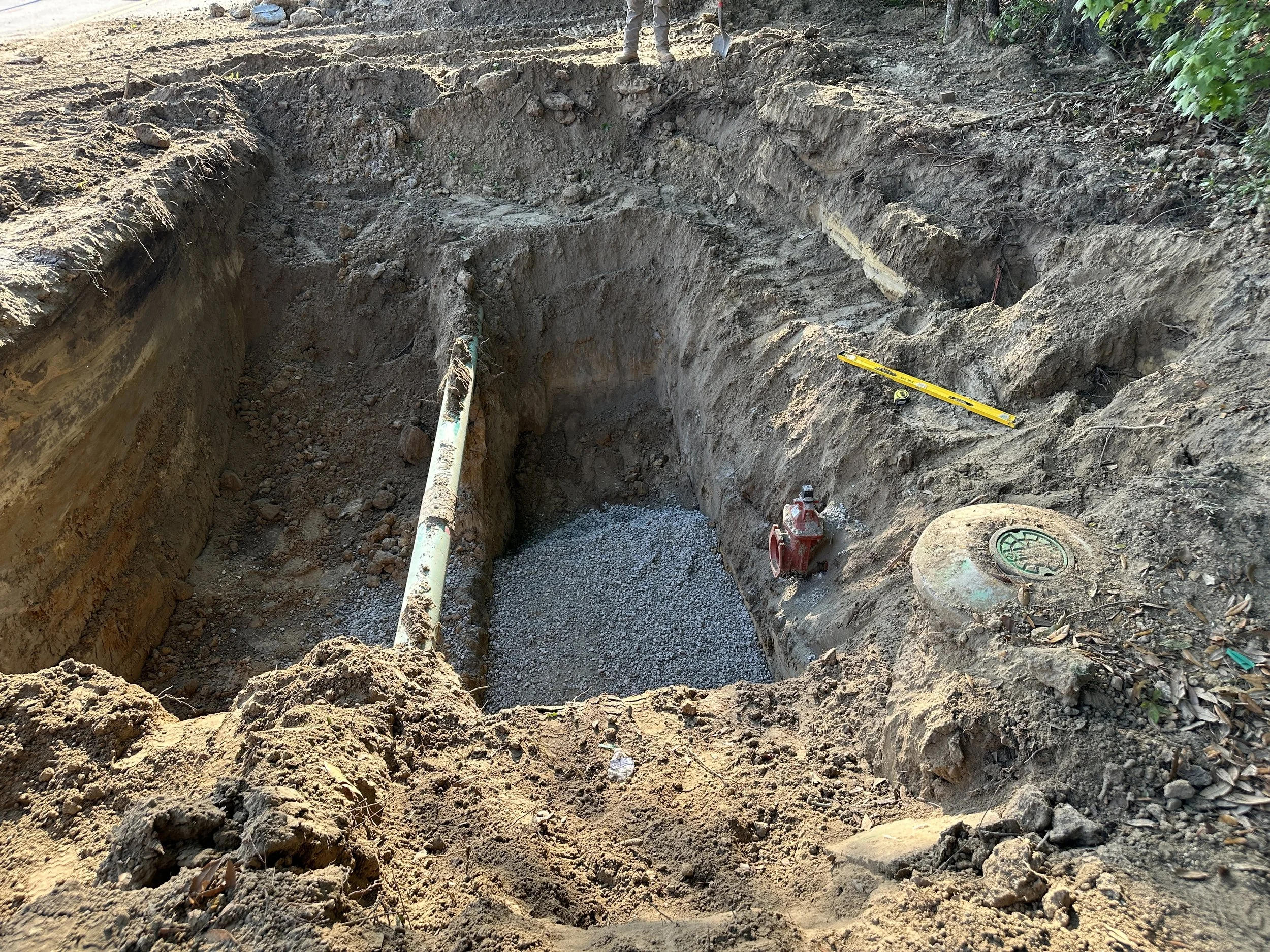 prep for manhole location in between gas line and sewer force main