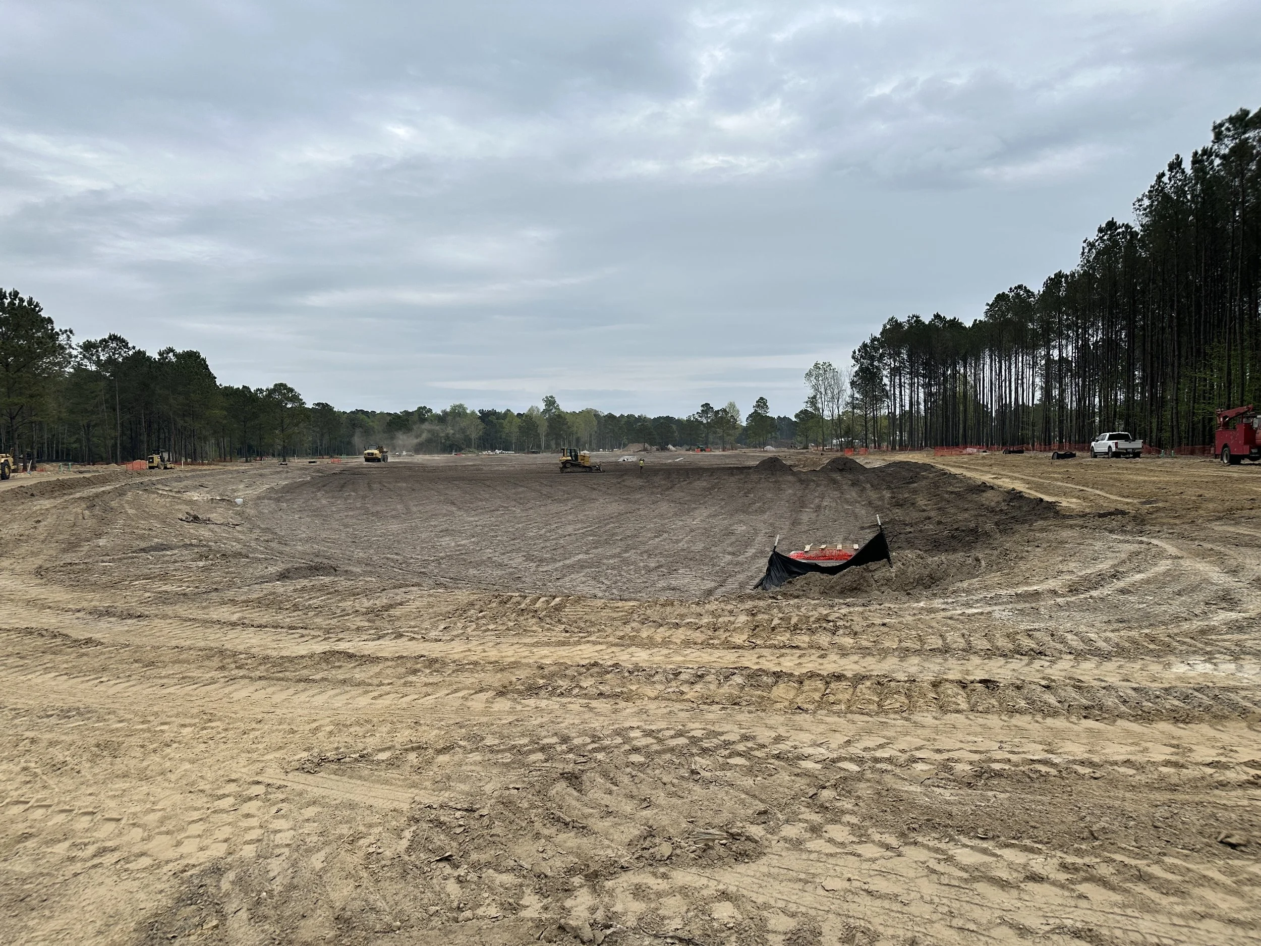 dry pond getting topsoil added to final grading