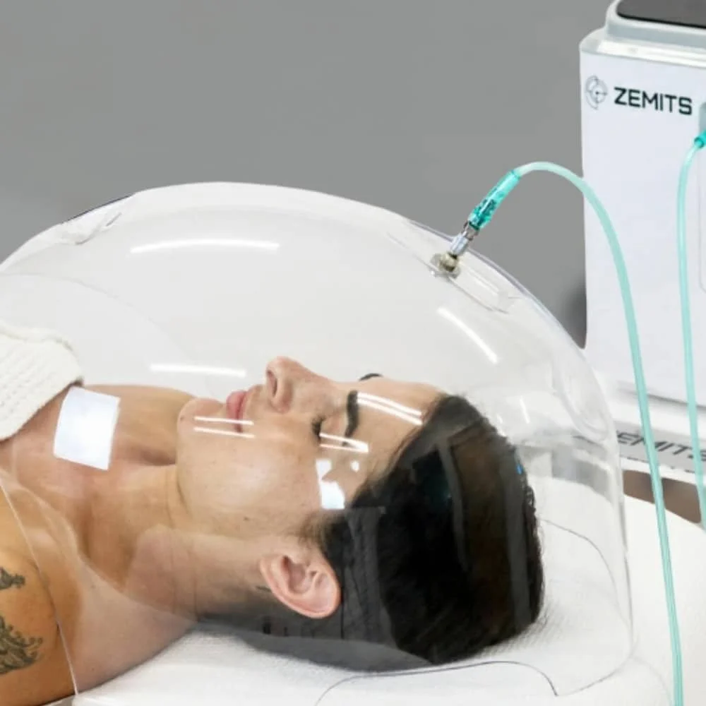 client laying under the Oxyvelour Treatment Oxygen Dome