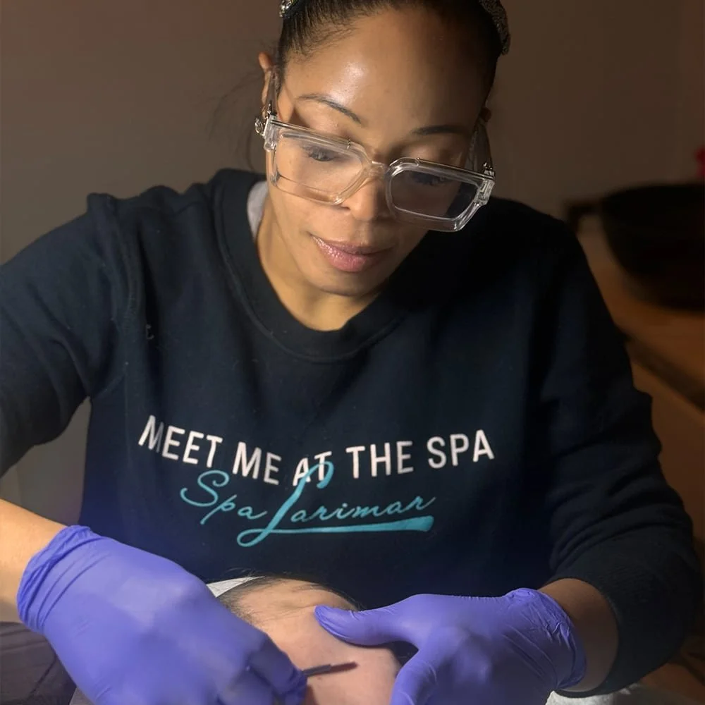 Spa Larimar esthetician performing dermaplaning treatment on a client