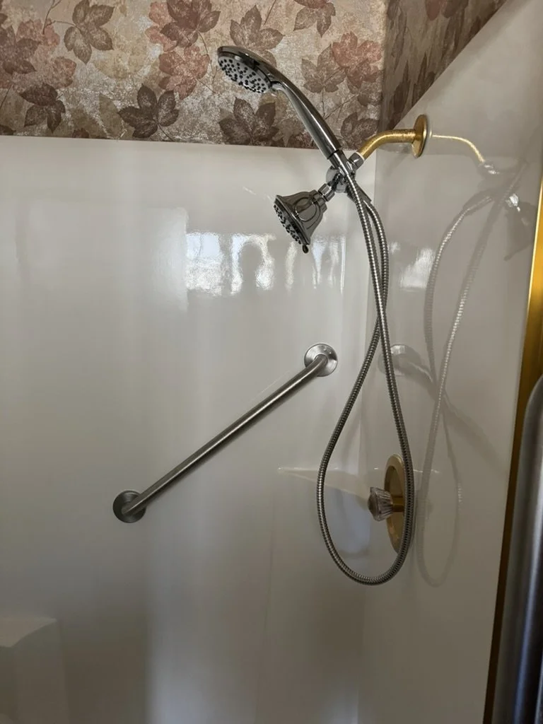 Angled grab bar with handheld showerhead, bathroom accessibility upgrade
