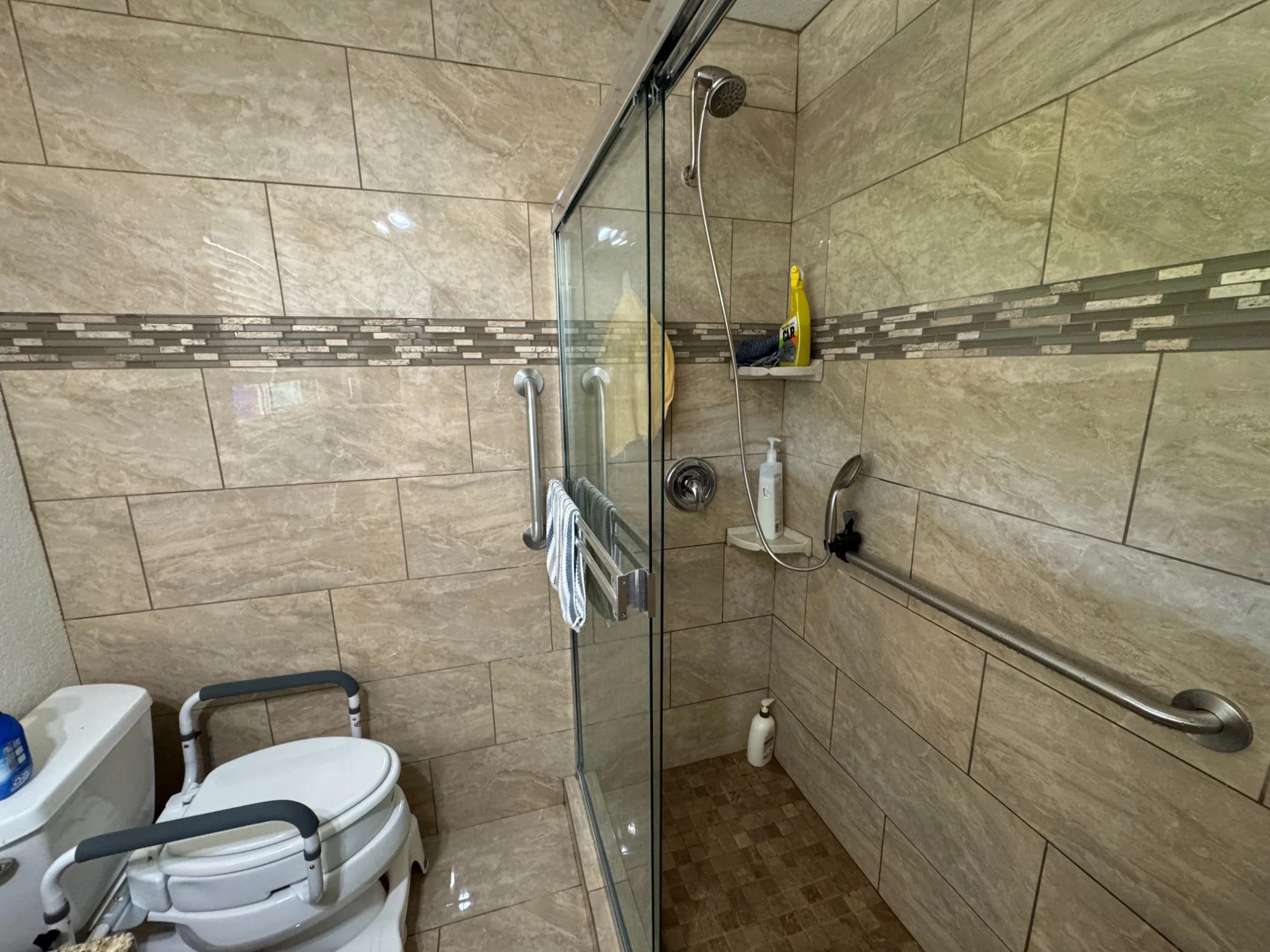 Walk-in shower with grab bars and raised toilet seat safety frame, home accessibility upgrade Northern California