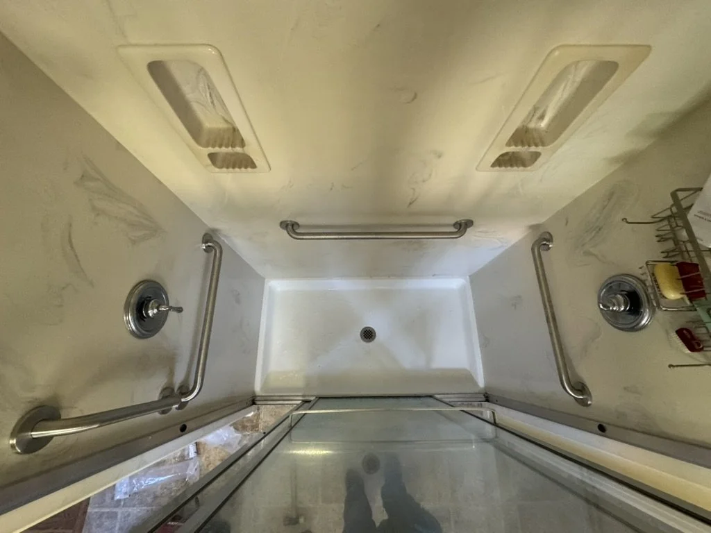 Overhead view of four grab bars installed in bathtub, comprehensive accessibility modification