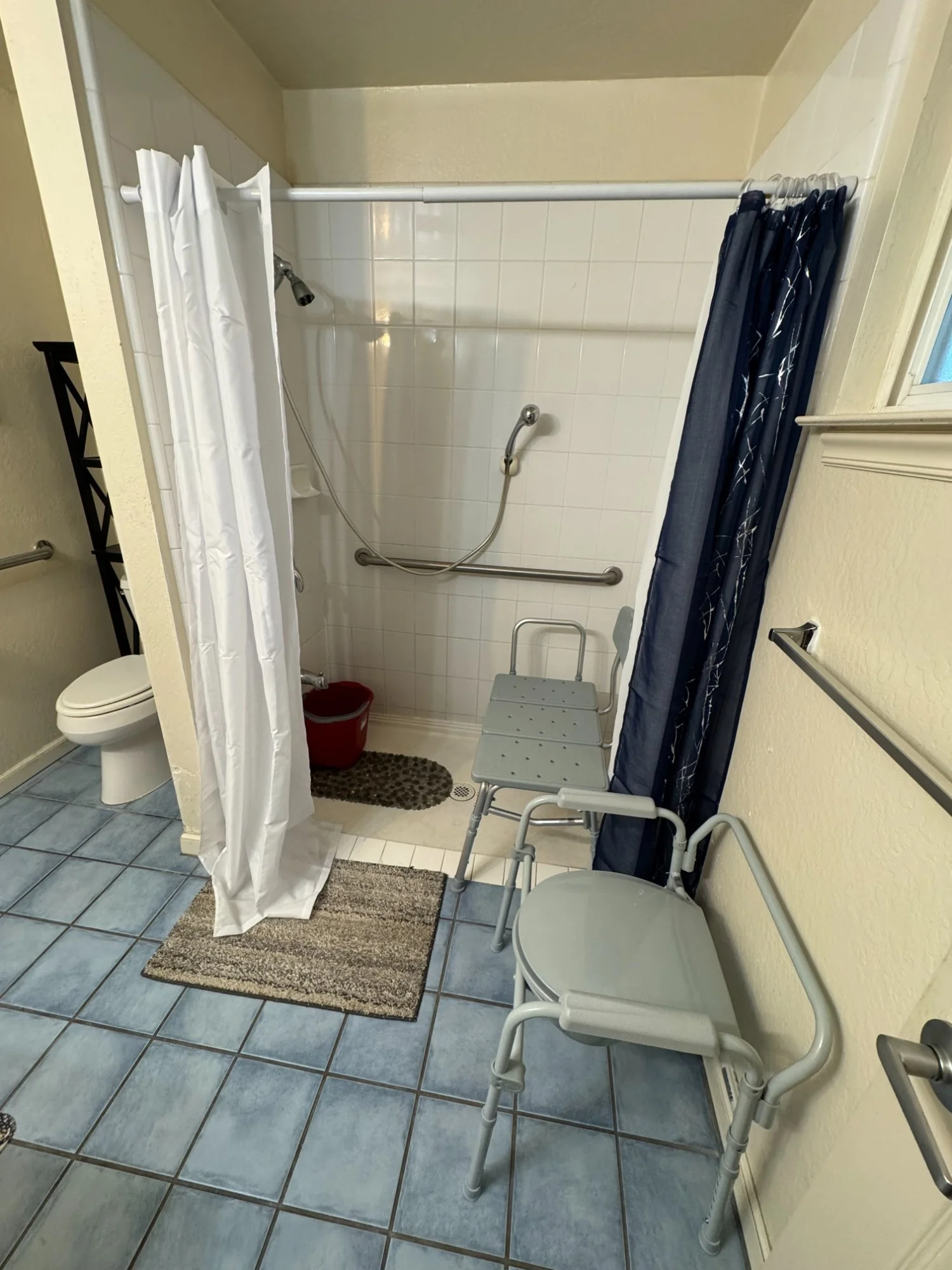 Walk-in shower with grab bars and shower bench, residential accessibility installation