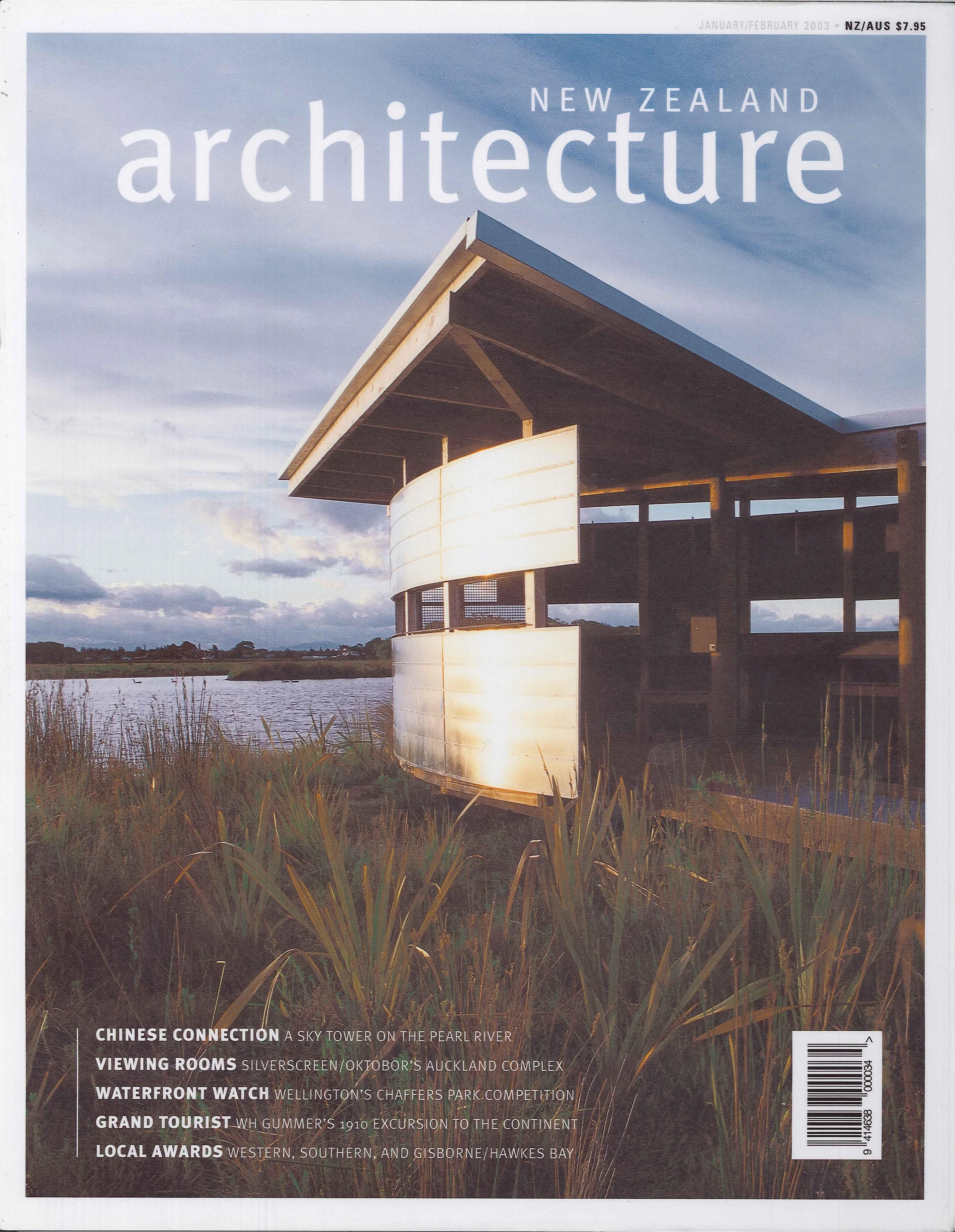 Cover of New Zealand architecture magazine featuring a modern building near a body of water with tall grasses in the foreground and a mostly cloudy sky in the background.
