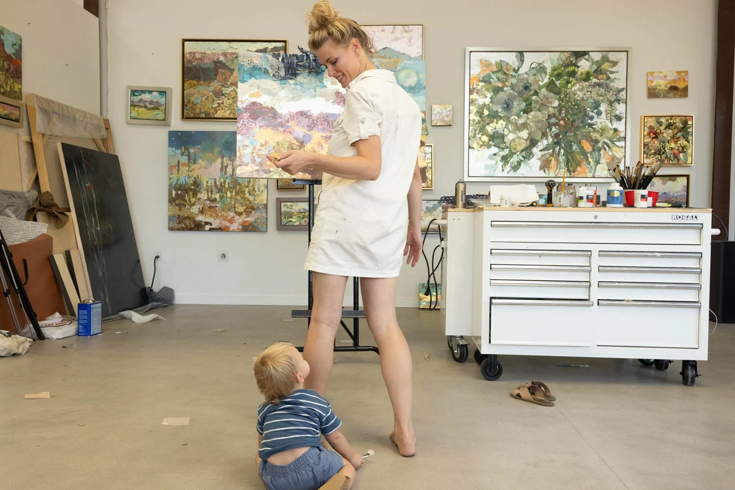 Artist Elizabeth Page looking at baby zack in studio