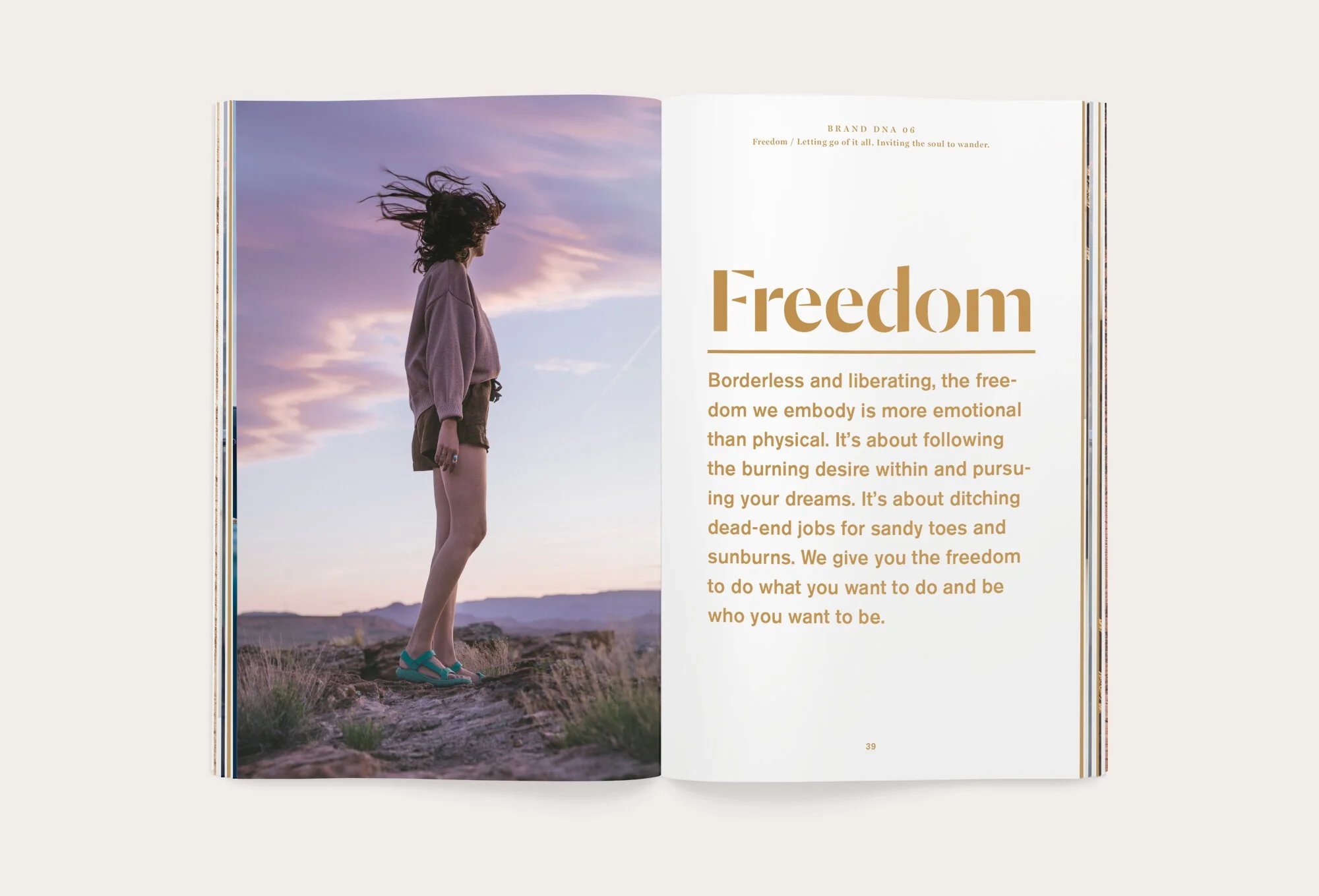 Open book with a photo of a woman standing on a rocky landscape at sunset on the left page, and the word 'Freedom' with a paragraph explaining its meaning on the right page.