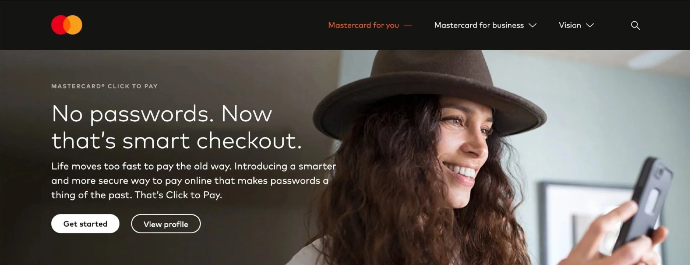 A woman wearing a brown hat smiling while looking at her phone, with a website promoting contactless checkout and Mastercard branding.