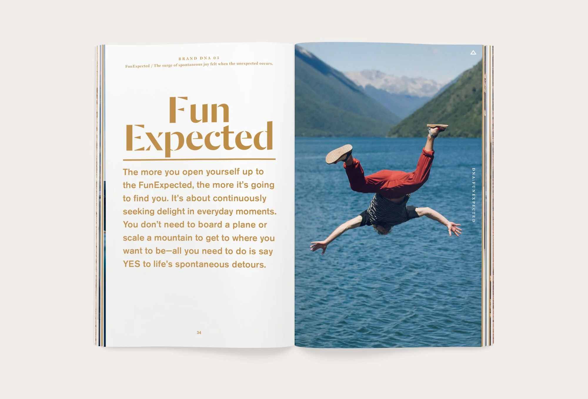Open book with text on the left page and a person falling into a lake on the right page. The person is upside down, wearing a striped shirt and red pants, with mountains in the background.