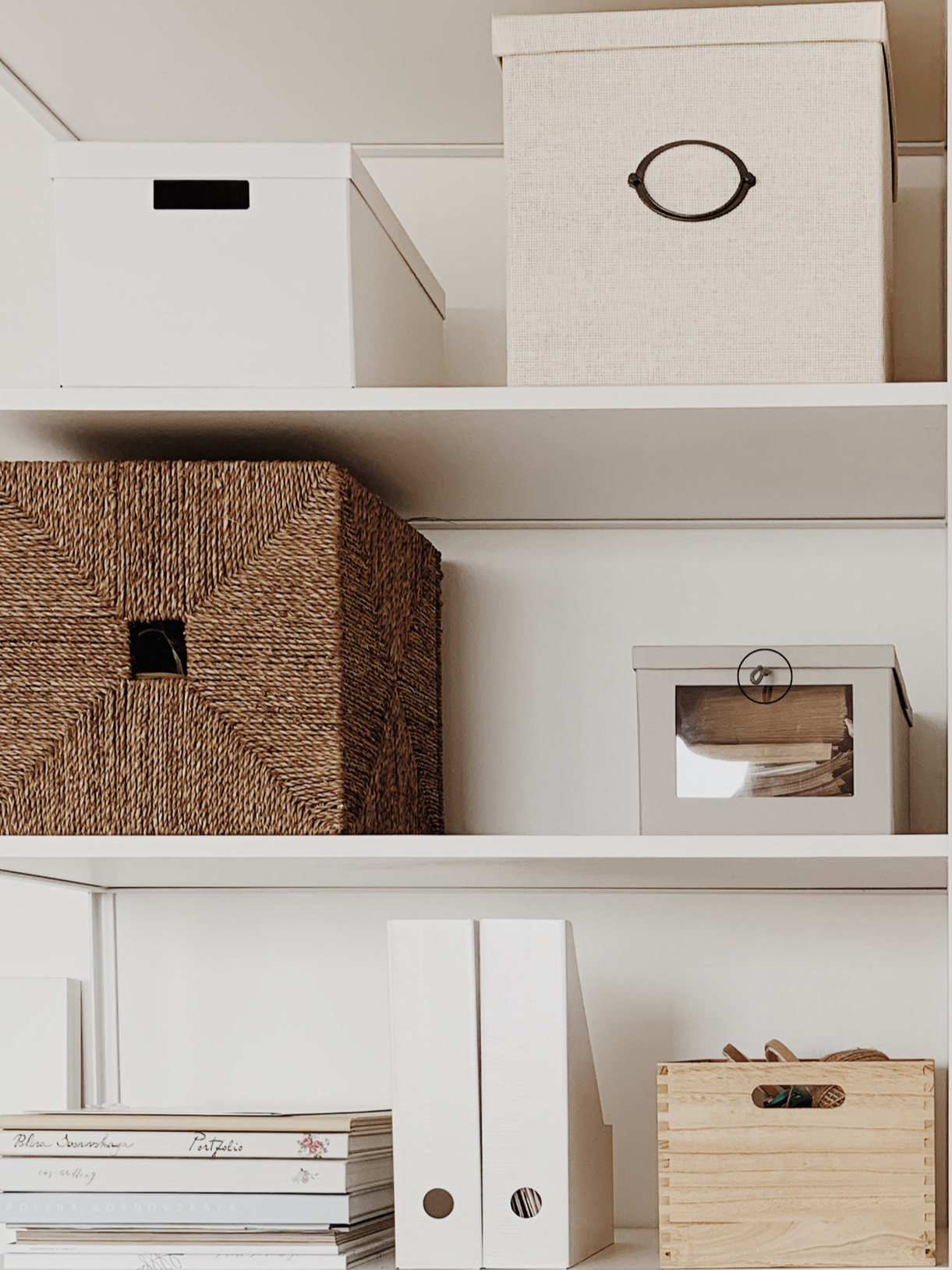 Shelves with neatly organized storage boxes, binders, and a wooden crate.