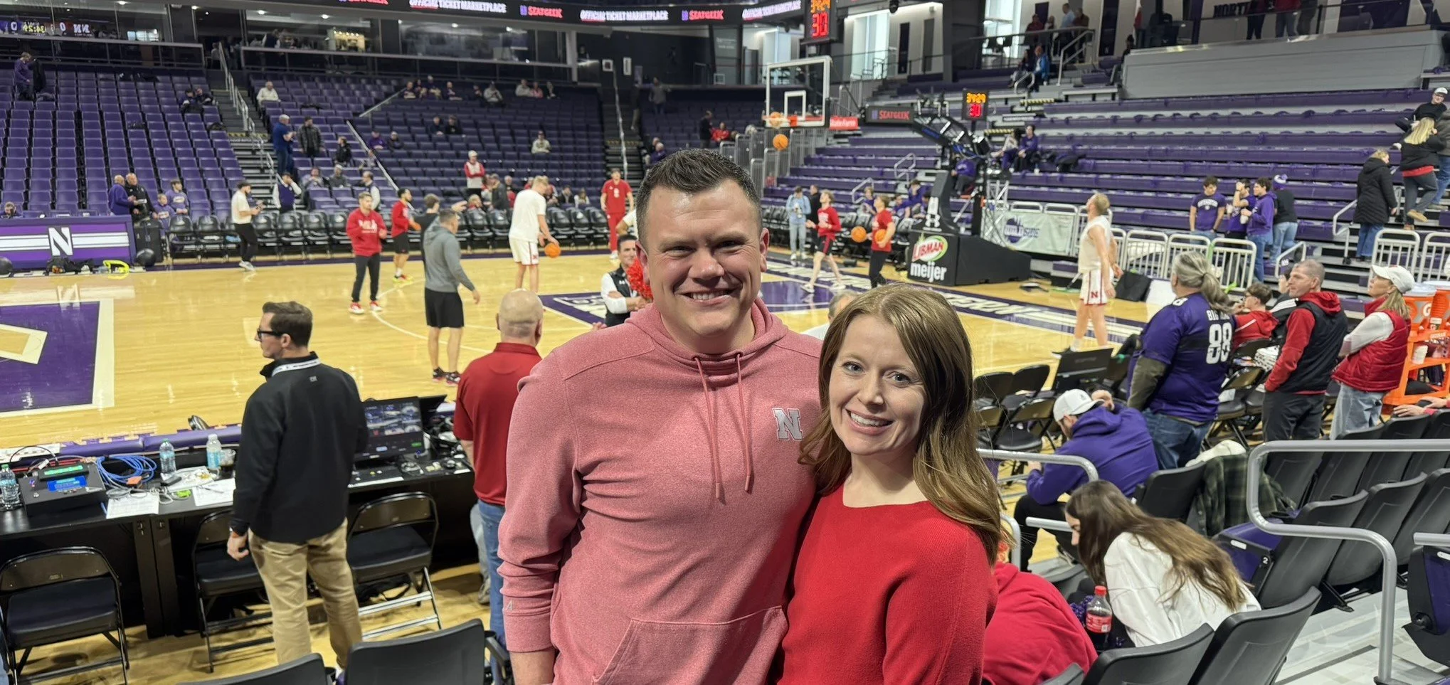 Justin and Megan cheering on the basketball team in Evanston, IL.