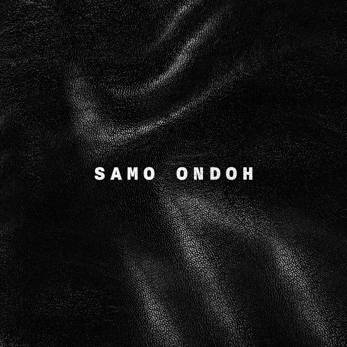 Close-up of black leather texture with the name 'SAMO ONDOH' in white capital letters at the center.