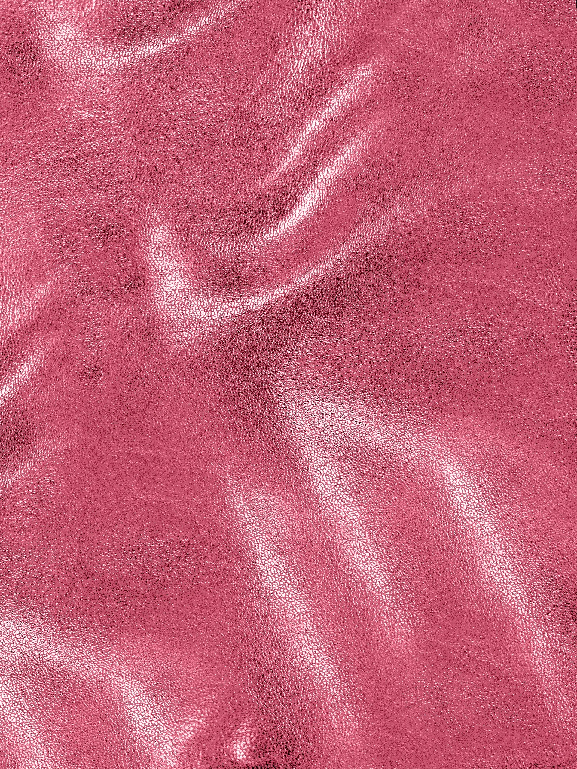 Close-up of pink textured leather fabric with visible grain and slight glossy finish.