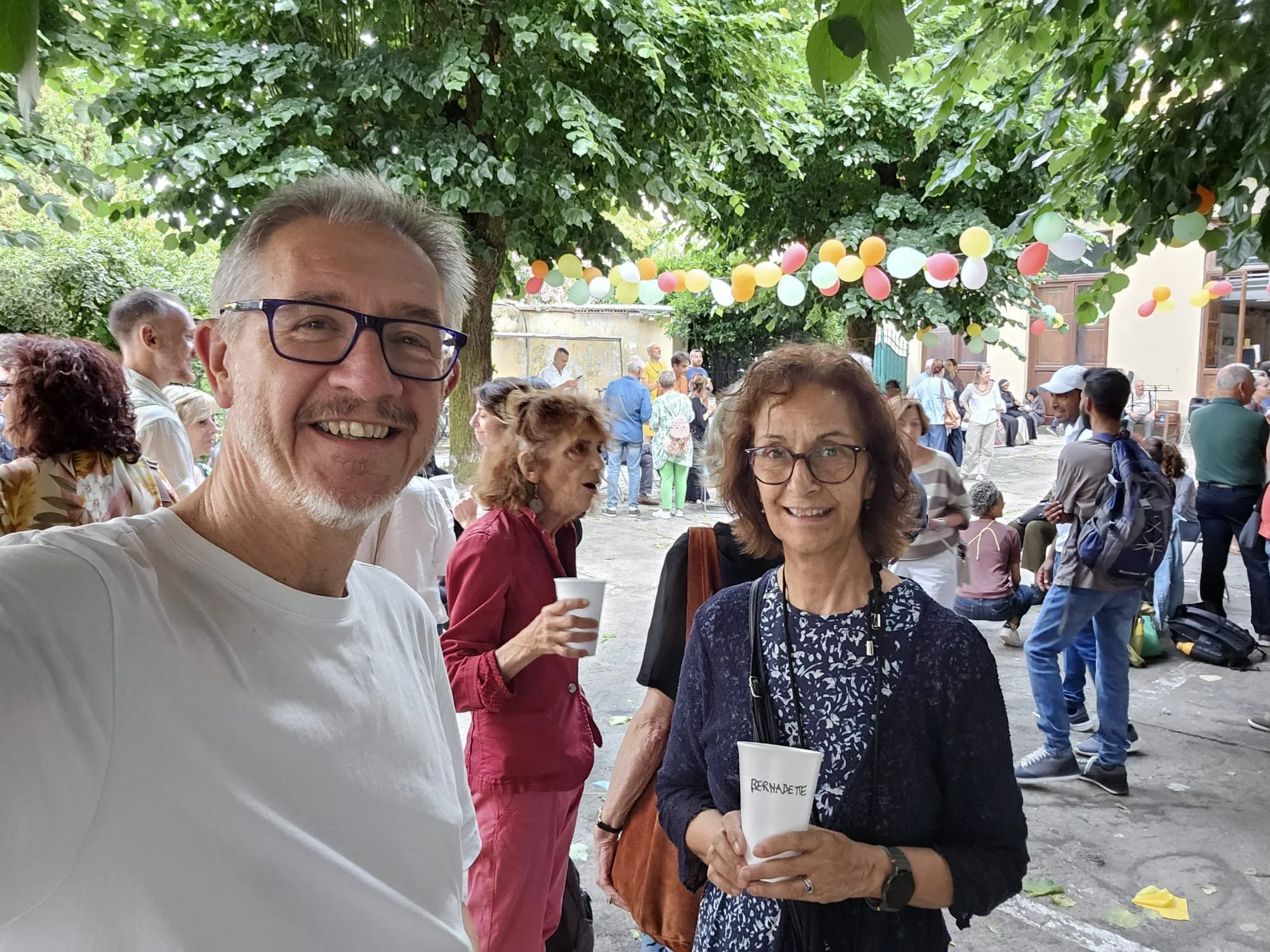 Father Chris and Bernadette meeting people at Arcobaleno