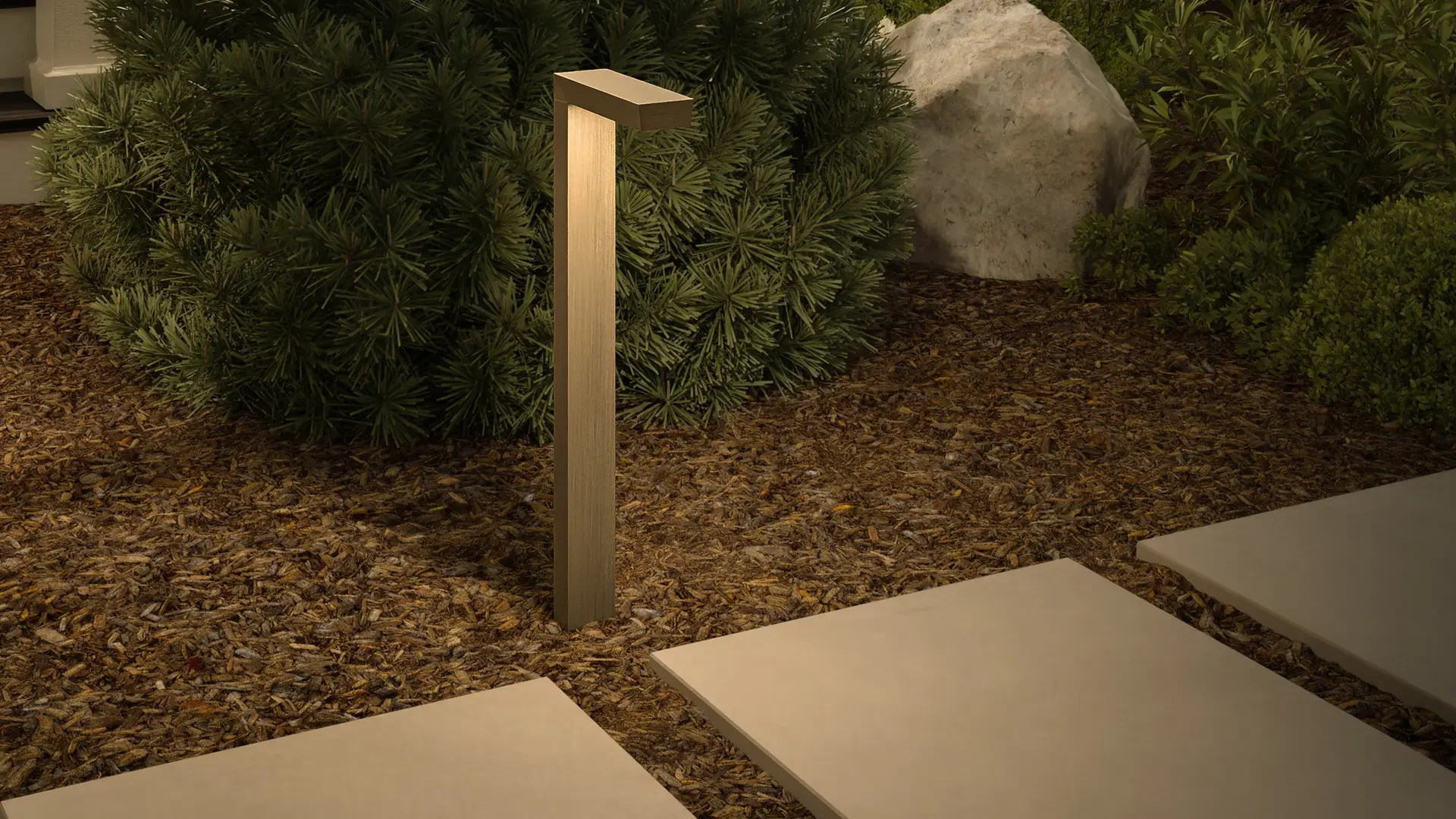Outdoor garden pathway with three concrete stepping stones, a landscape light fixture, green bushes, and a large rock.