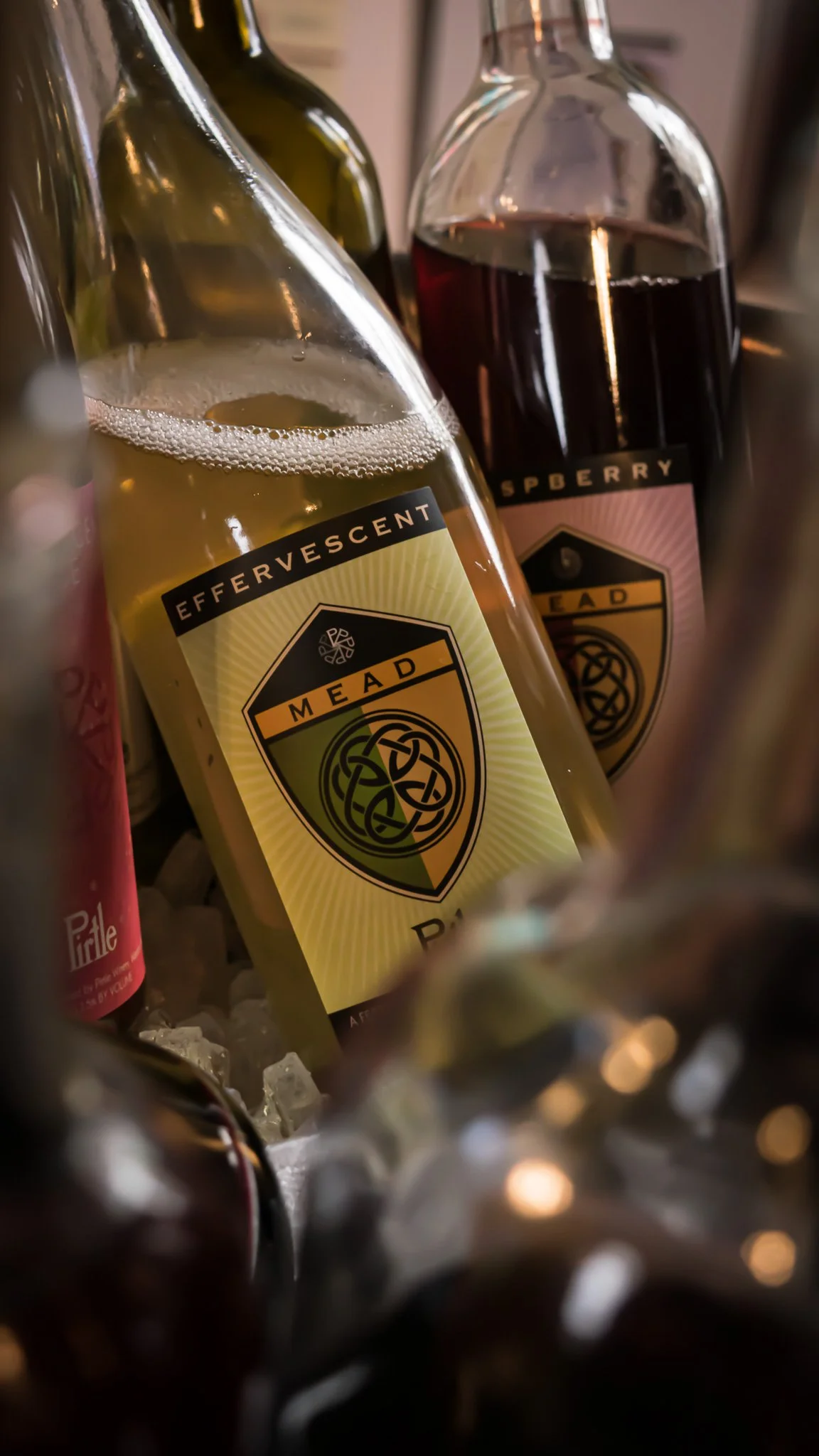 Bottles of Mead with Mix of red and white wine, some on ice in a cooler or bucket