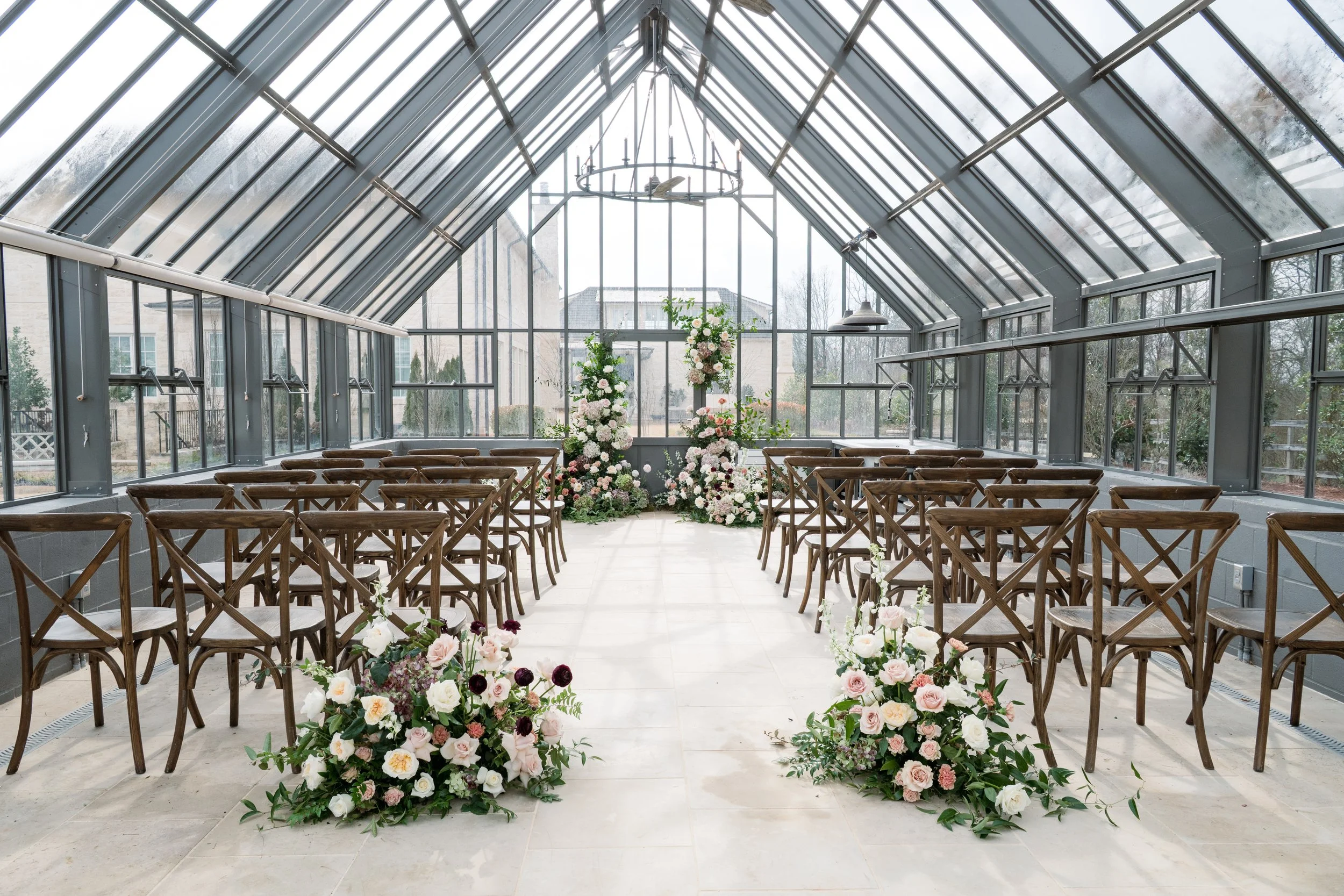 Ceremony location inside the greenhouse facing the main house