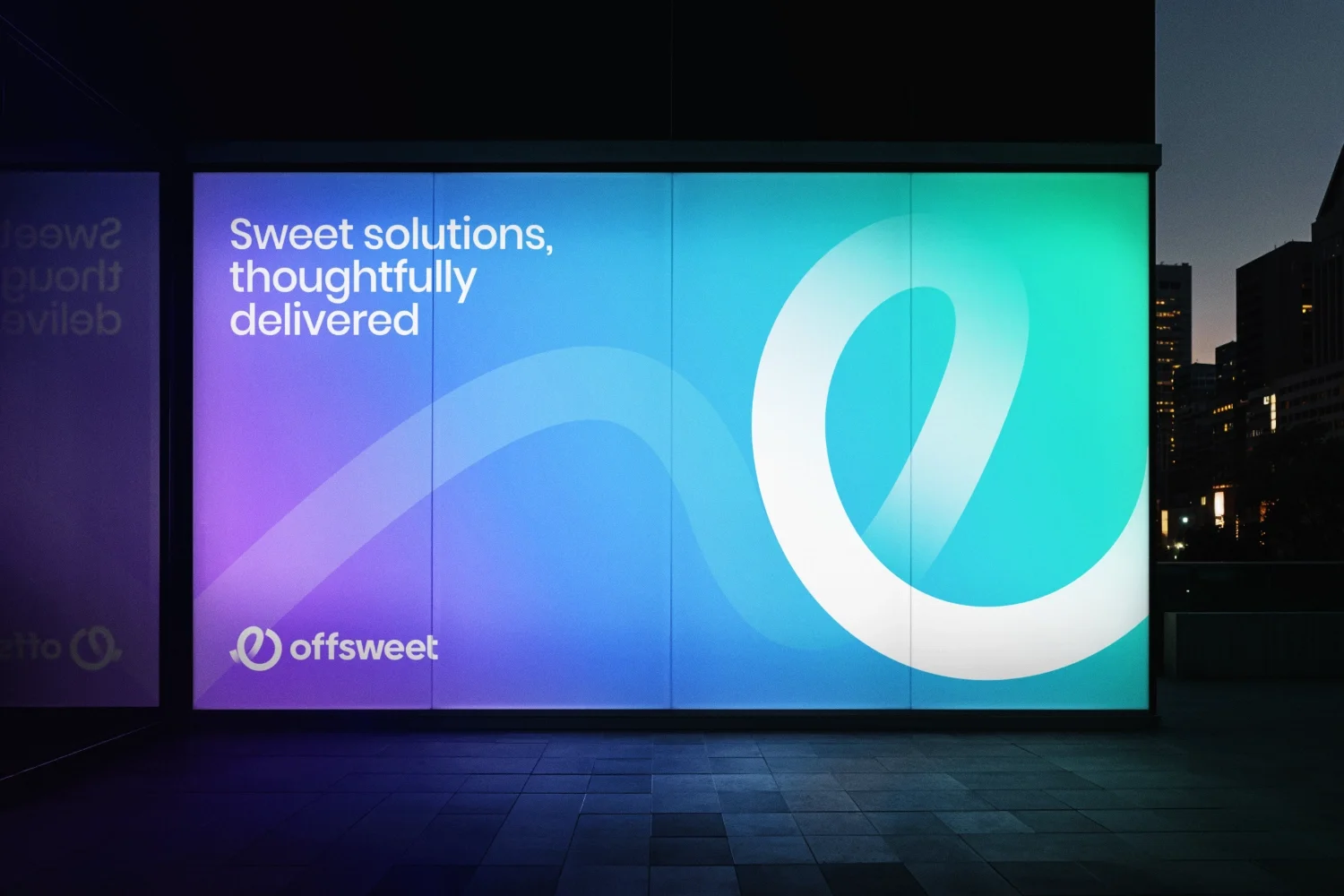 A large digital billboard displays the message 'Sweet solutions, thoughtfully delivered' and features the Offsweat logo with a stylized swoosh in the lower left corner. The background has a gradient of purple, blue, and green hues, with a cityscape visible in the distance during dusk.