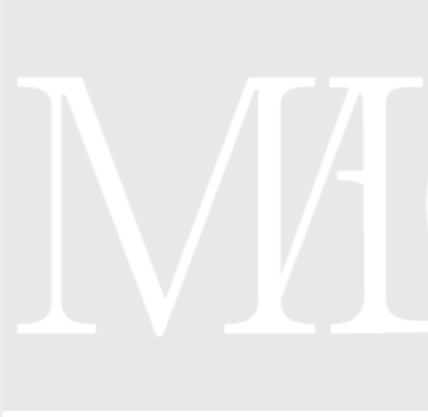 Close-up of a white 3D letter M on a light gray background.