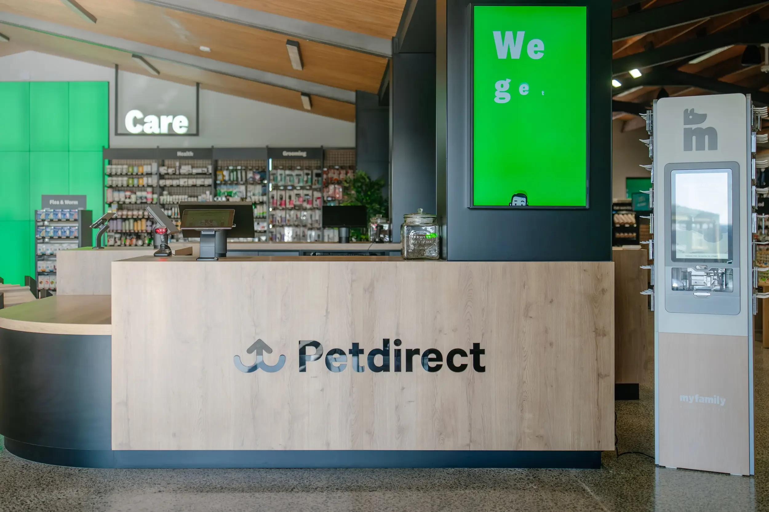Interior of Petdirect retail store with large marketing screen