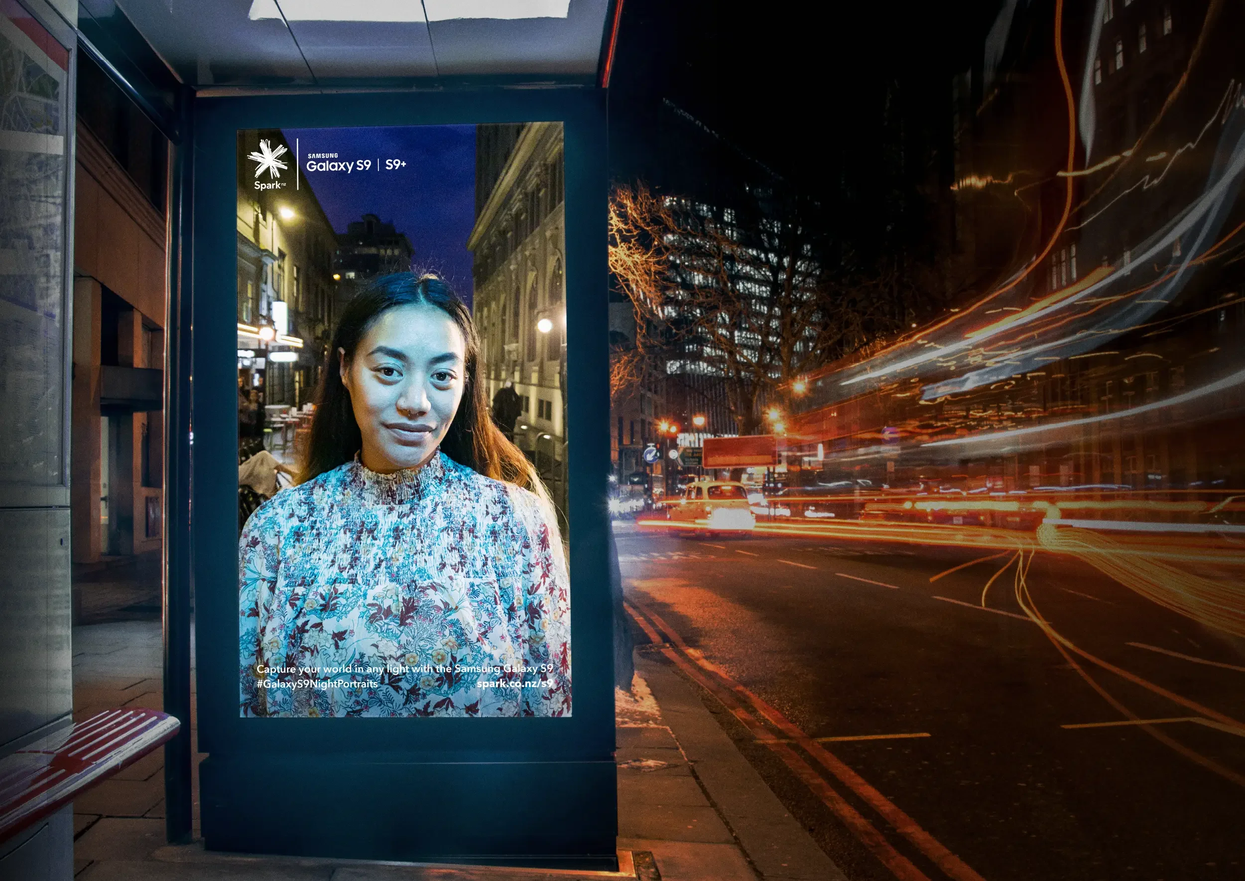 Portrait of woman photographed at night displayed in urban bus shelter as part of Samsung Night Portraits