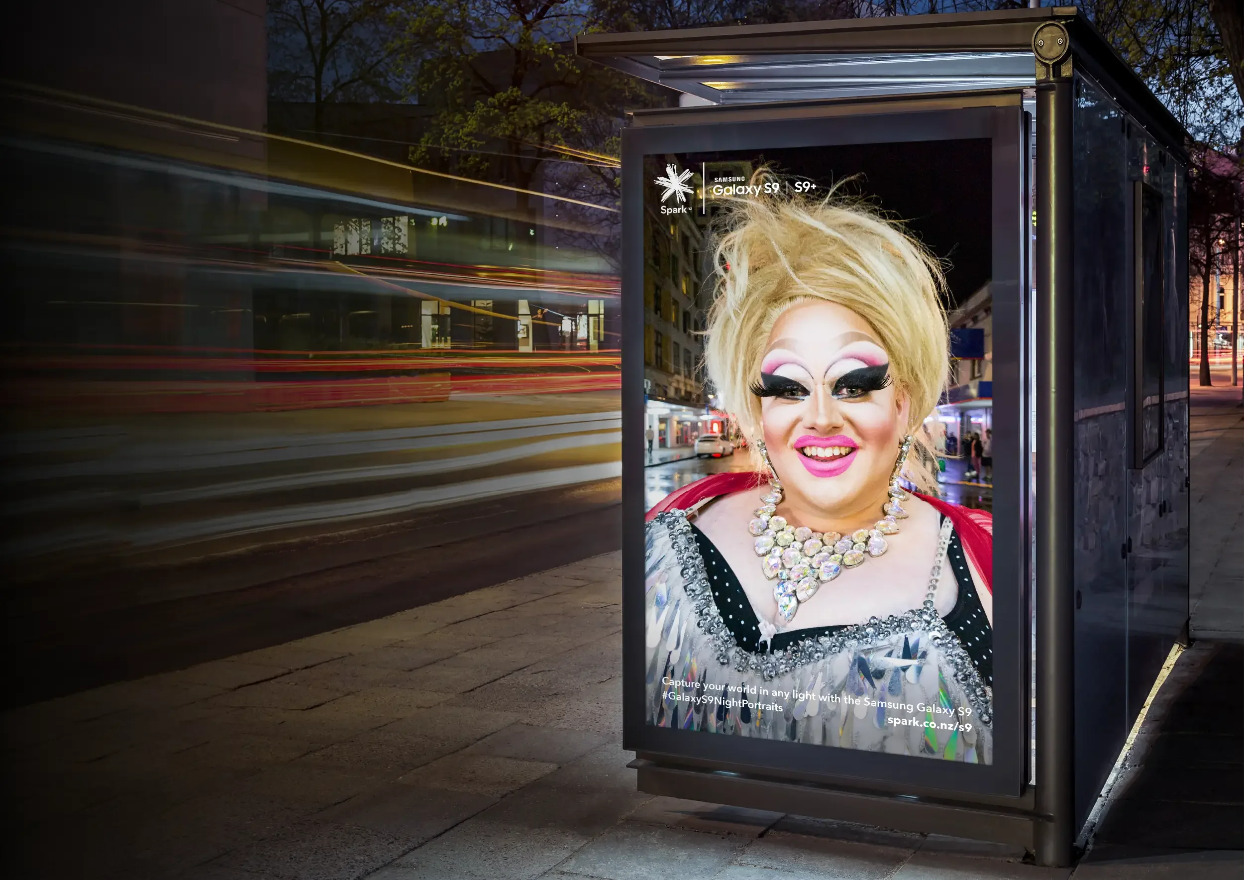 Drag performer portrait displayed on city billboard at night for Samsung Night Portraits campaign