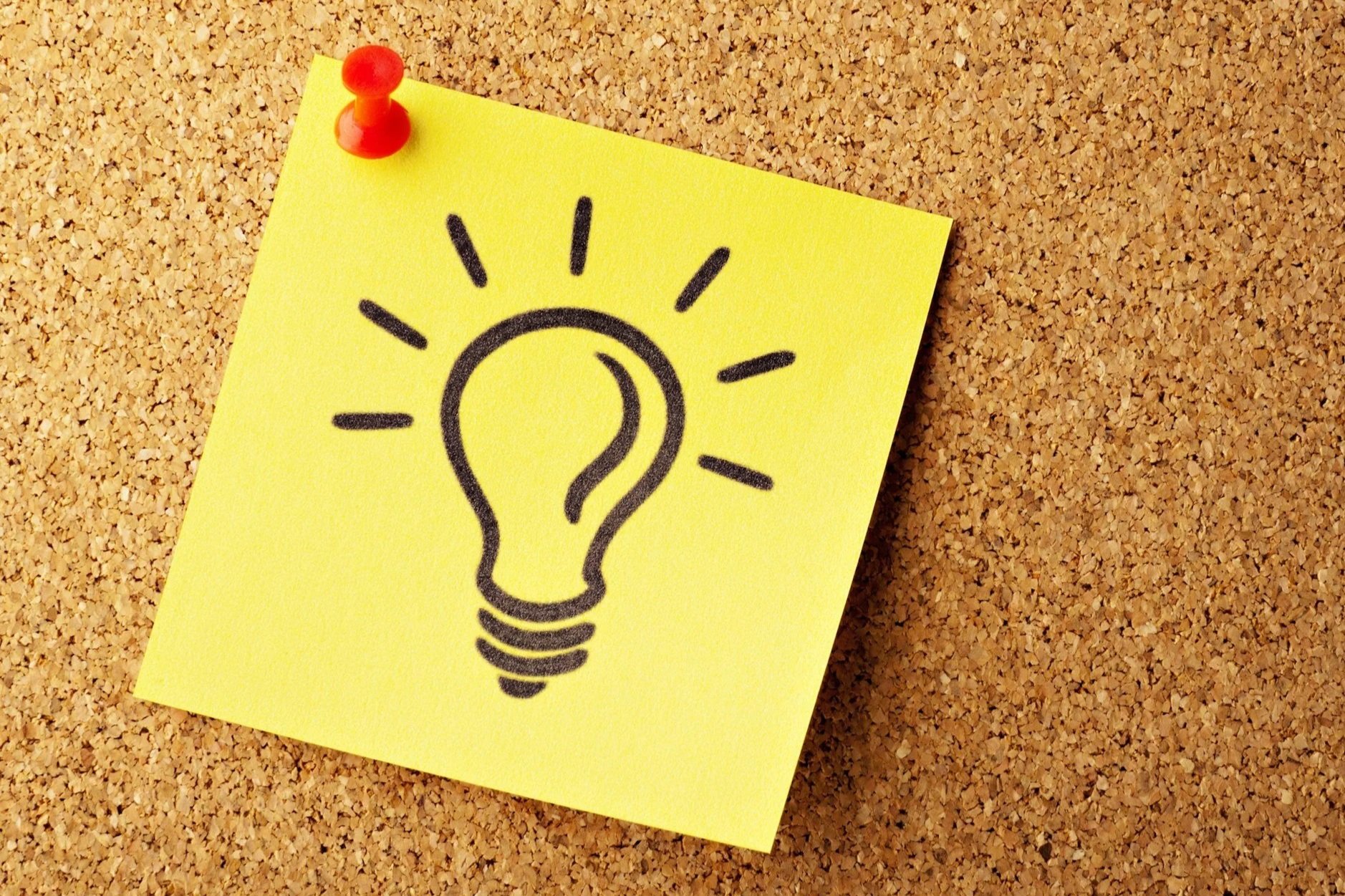 Coreboard with a post it note pinned to it, showing the drawing of a lightbulb to symbolize generating new ideas.
