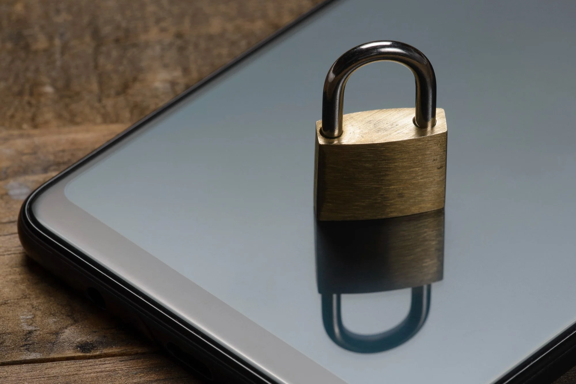 Padlock on a smartphone representing managed cyber security and IoT protection.