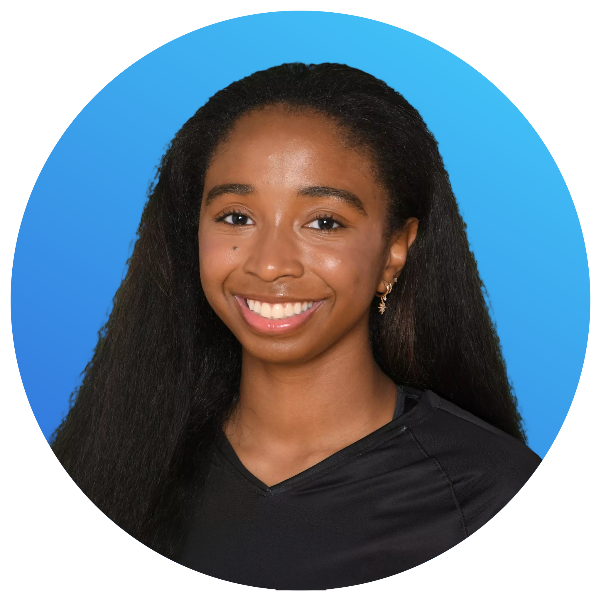 A young woman with long, curly black hair smiling, wearing earrings and a black top, against a blue background.