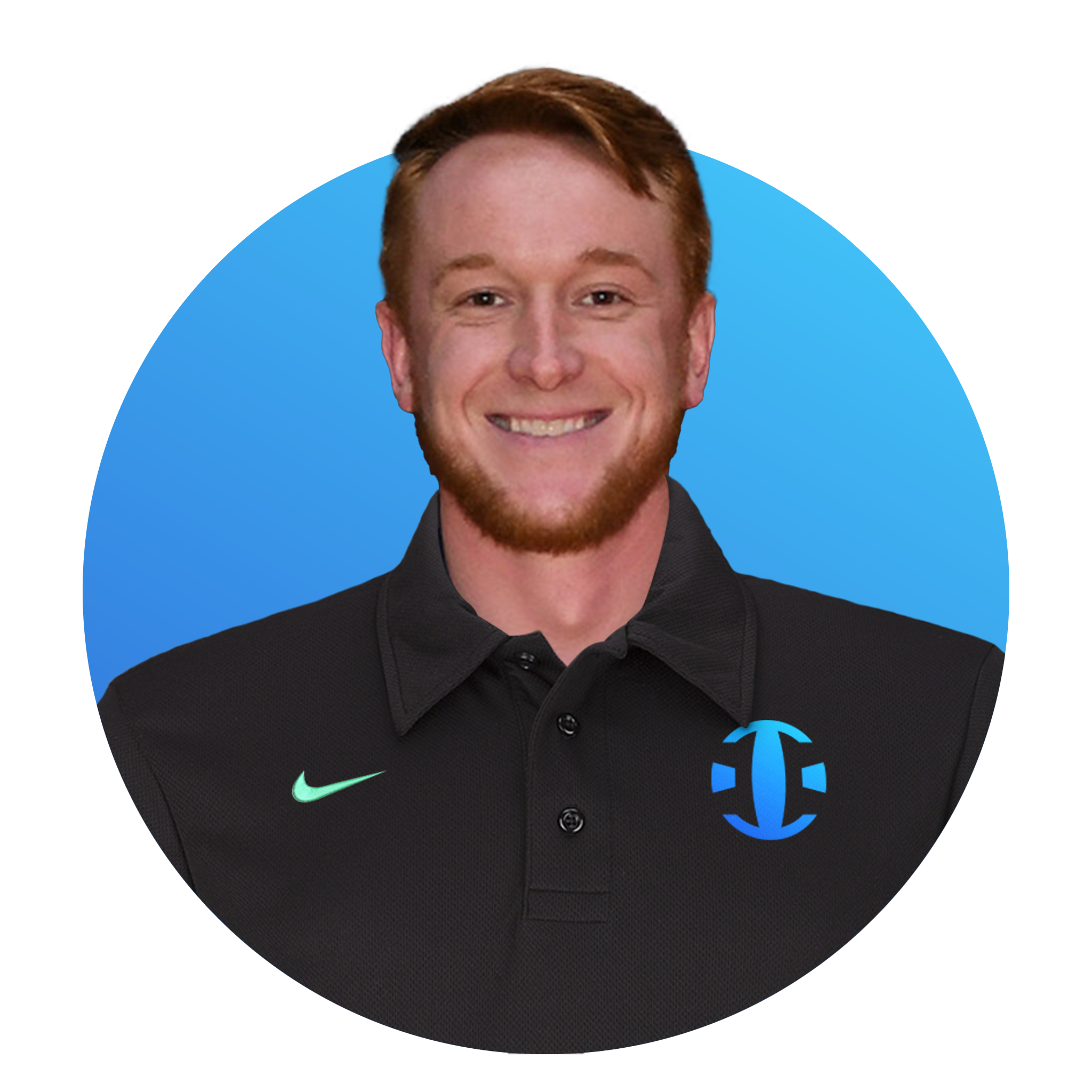 A young man with red hair, beard, and a big smile, wearing a black collared Nike shirt with a teal logo on the right side and a blue logo on the left side, standing in front of a blue background.